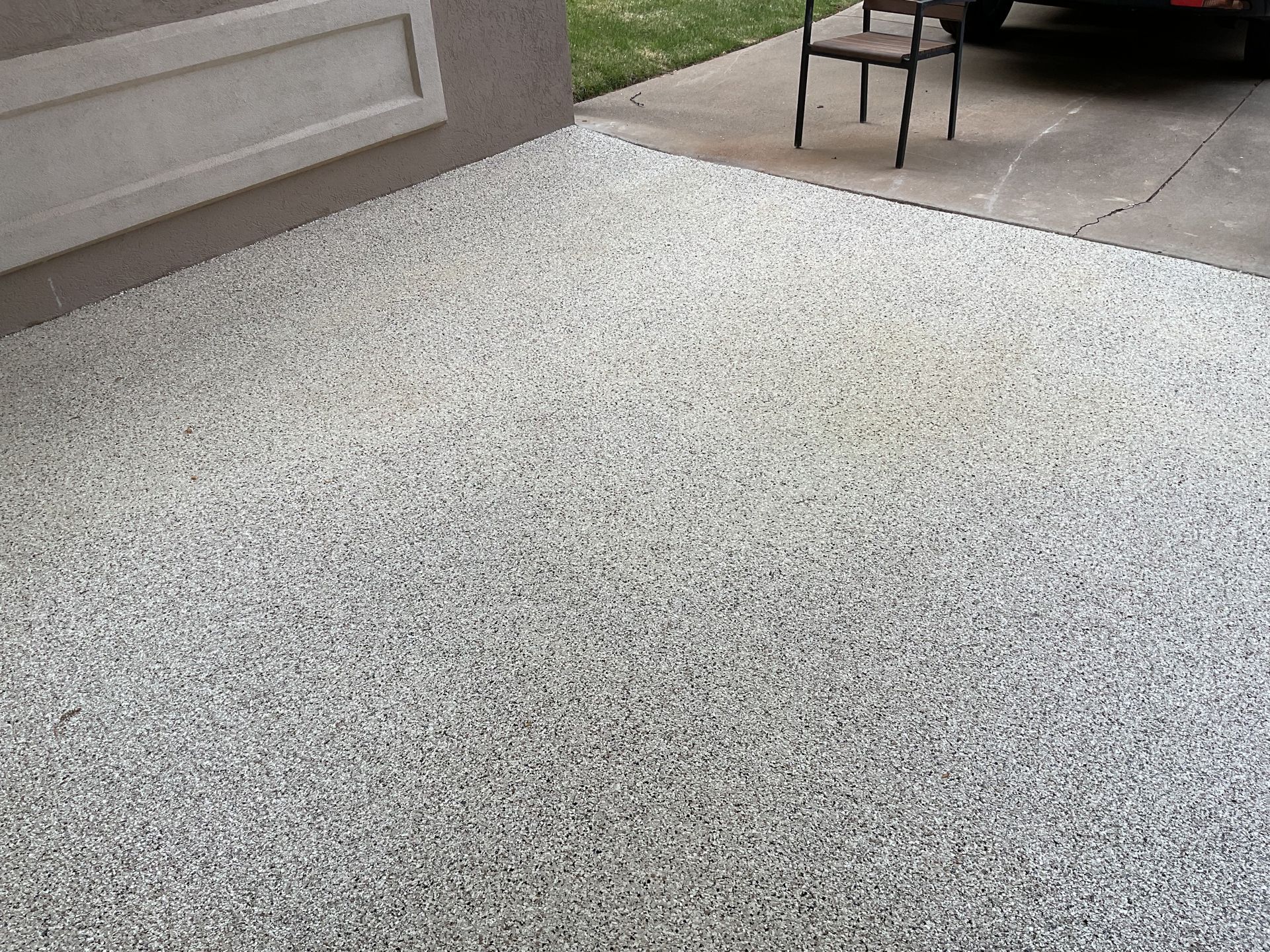 Epoxy flake finish near garage entryway installed by Zachary Daniel Concrete in Bostic, NC.