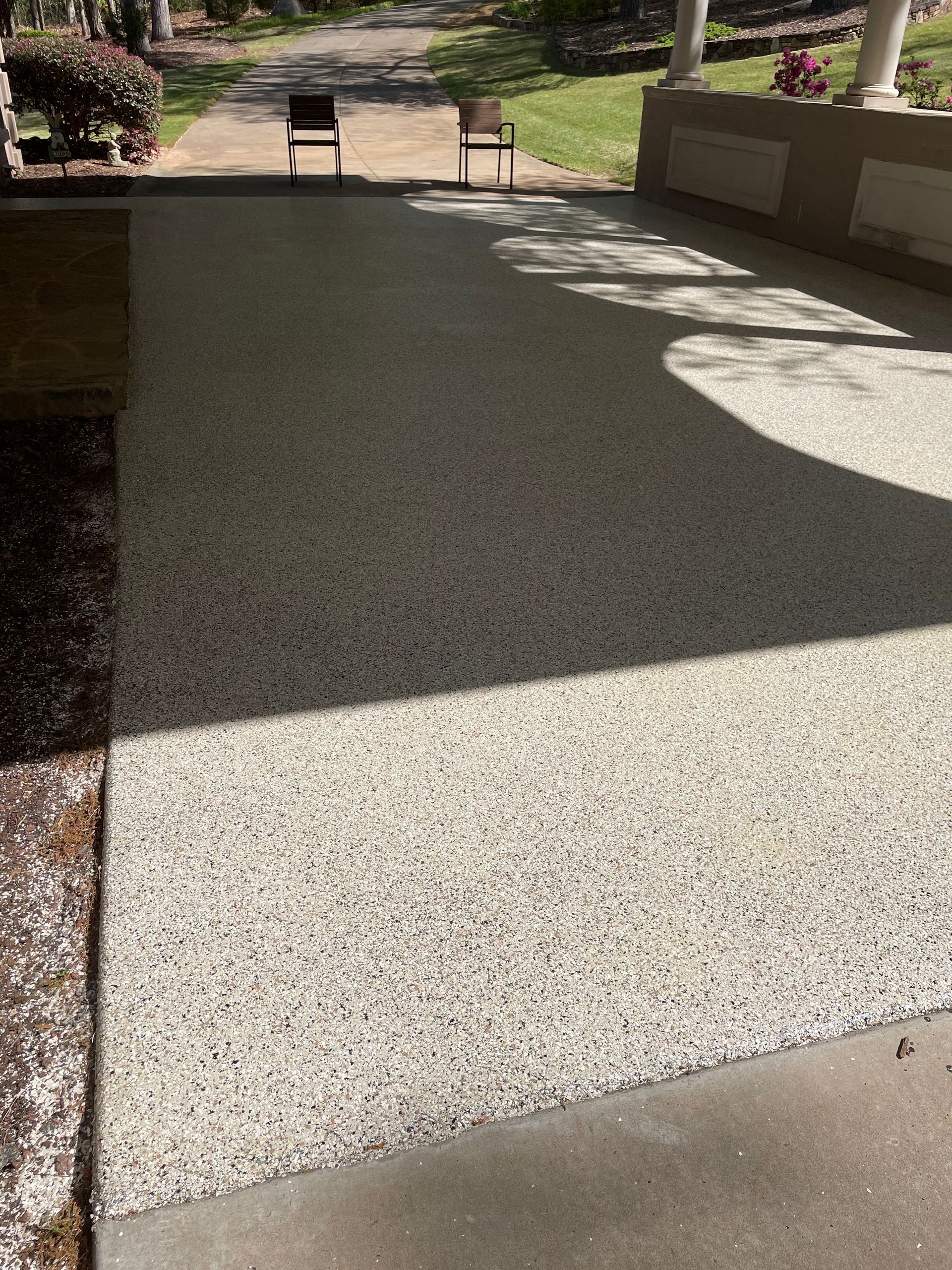 Close-up of epoxy flake floor with light reflection installed by Zachary Daniel Concrete in Forest City, NC.
