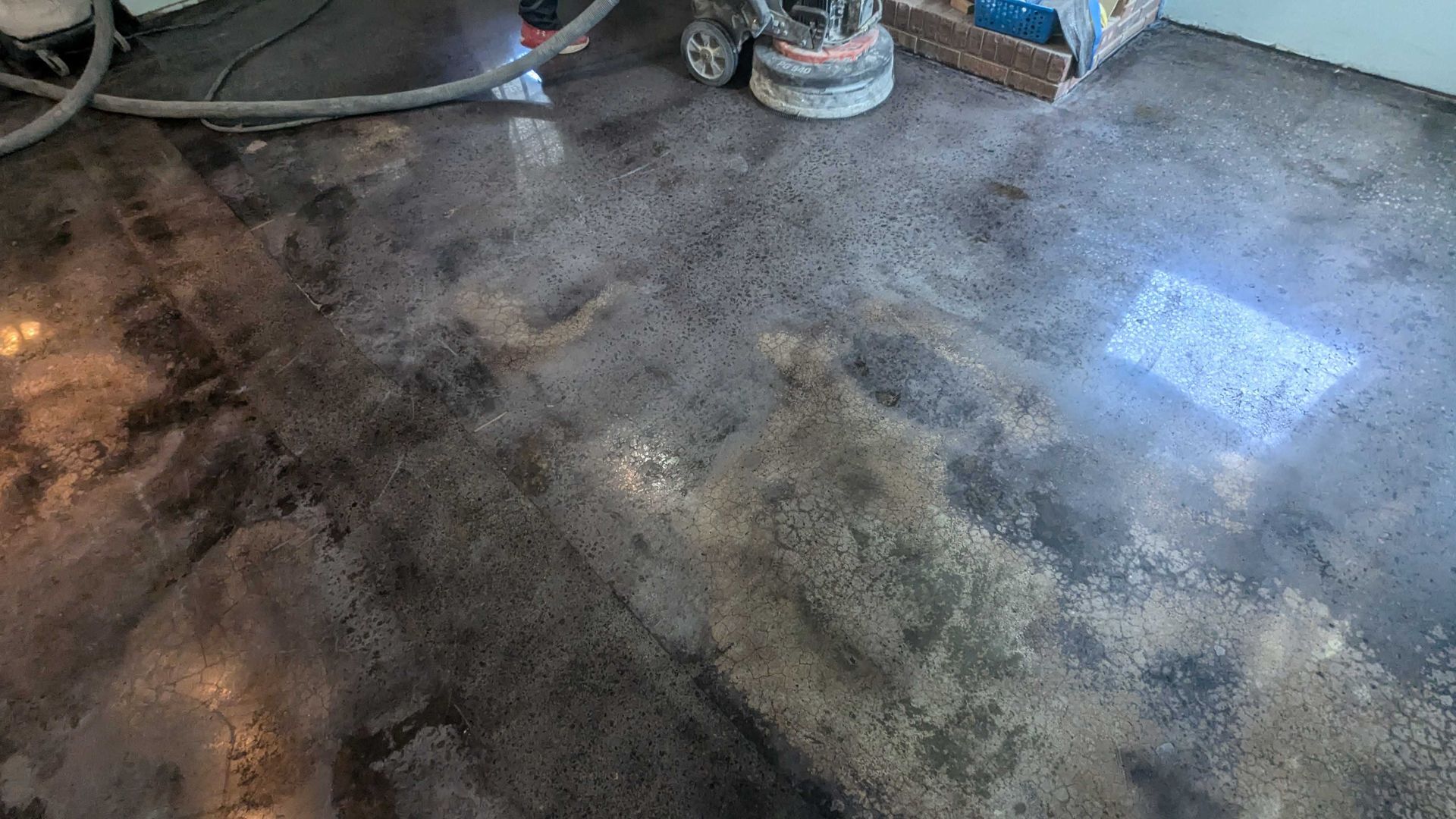 A concrete floor with a vacuum cleaner on it.