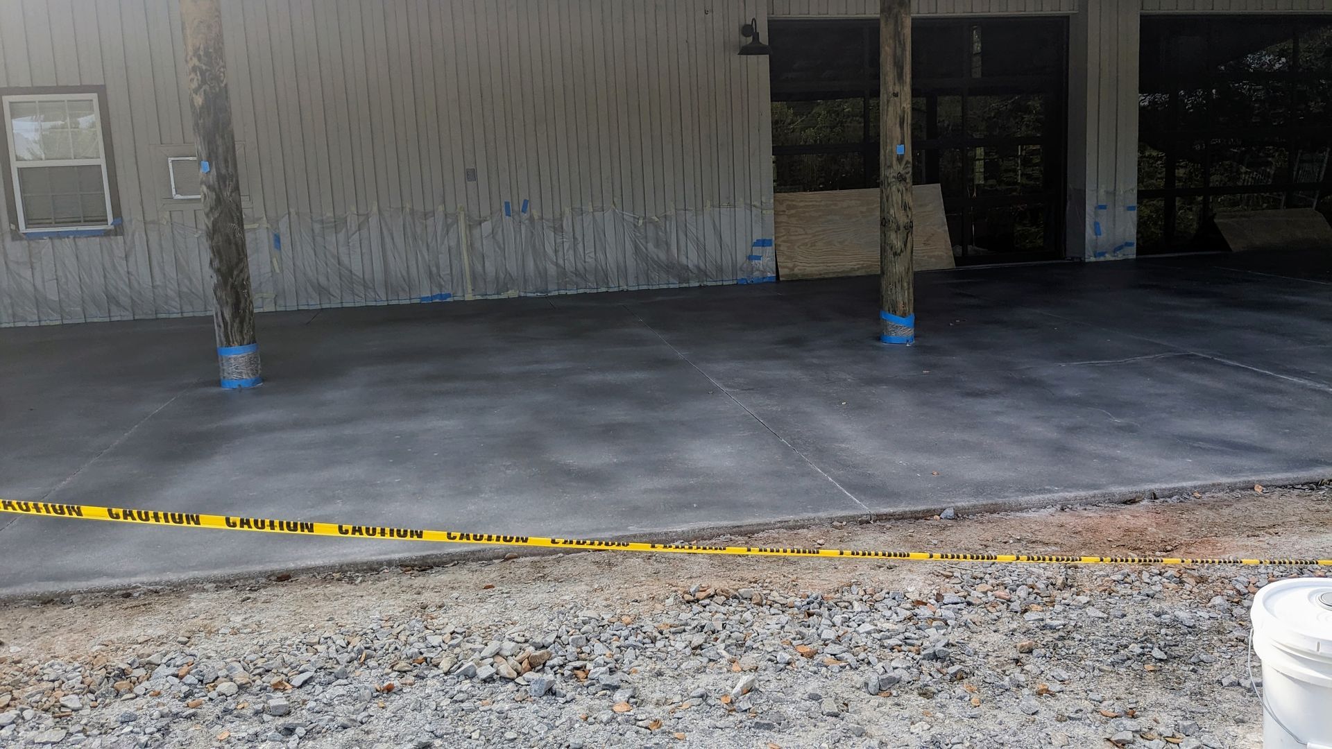 A concrete driveway is being built in front of a house.