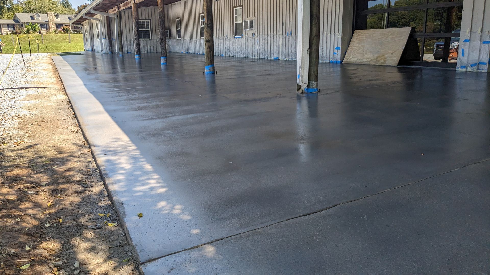 a concrete patio with a building in the background is being built .