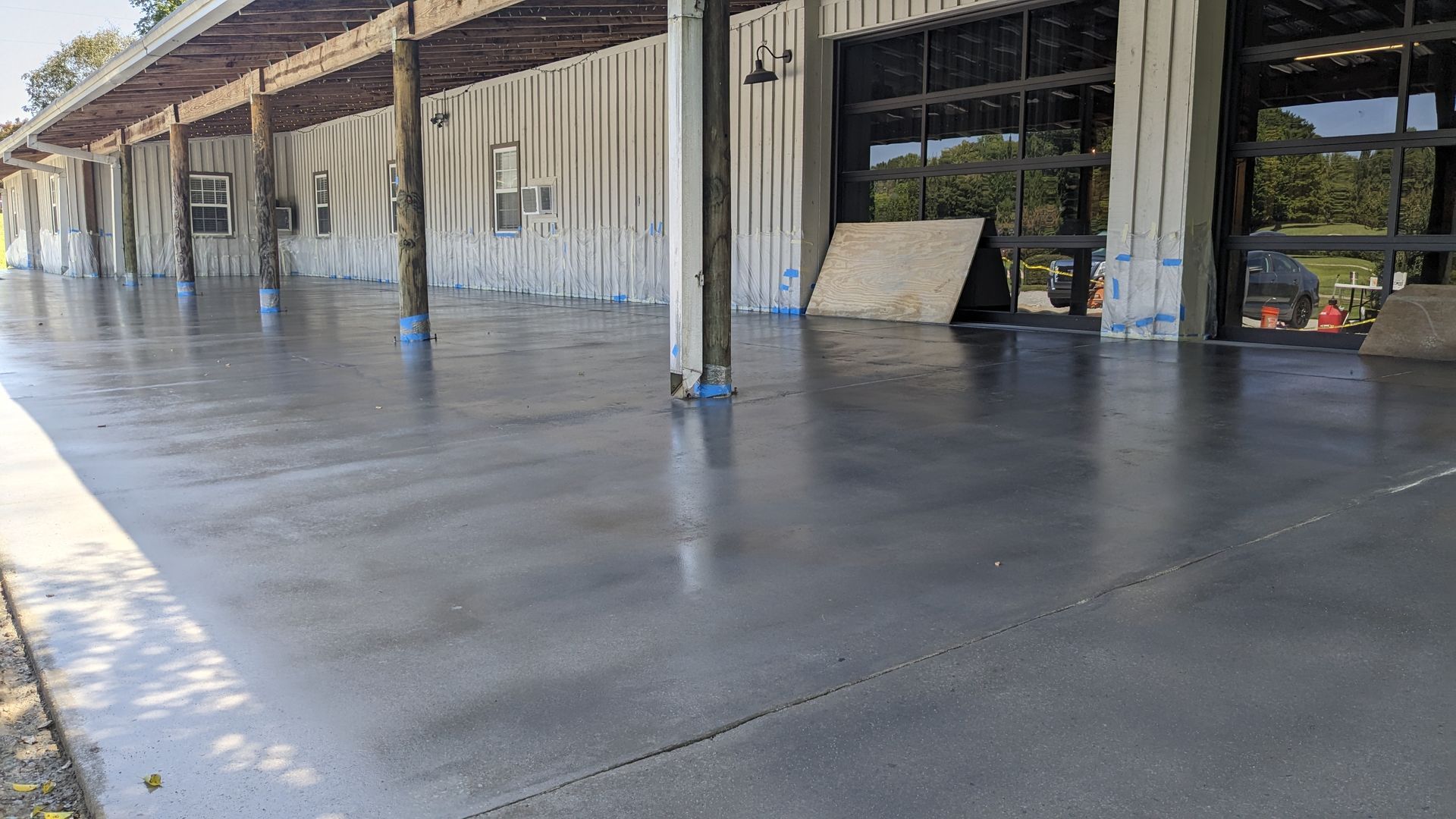 a large concrete driveway in front of a building .