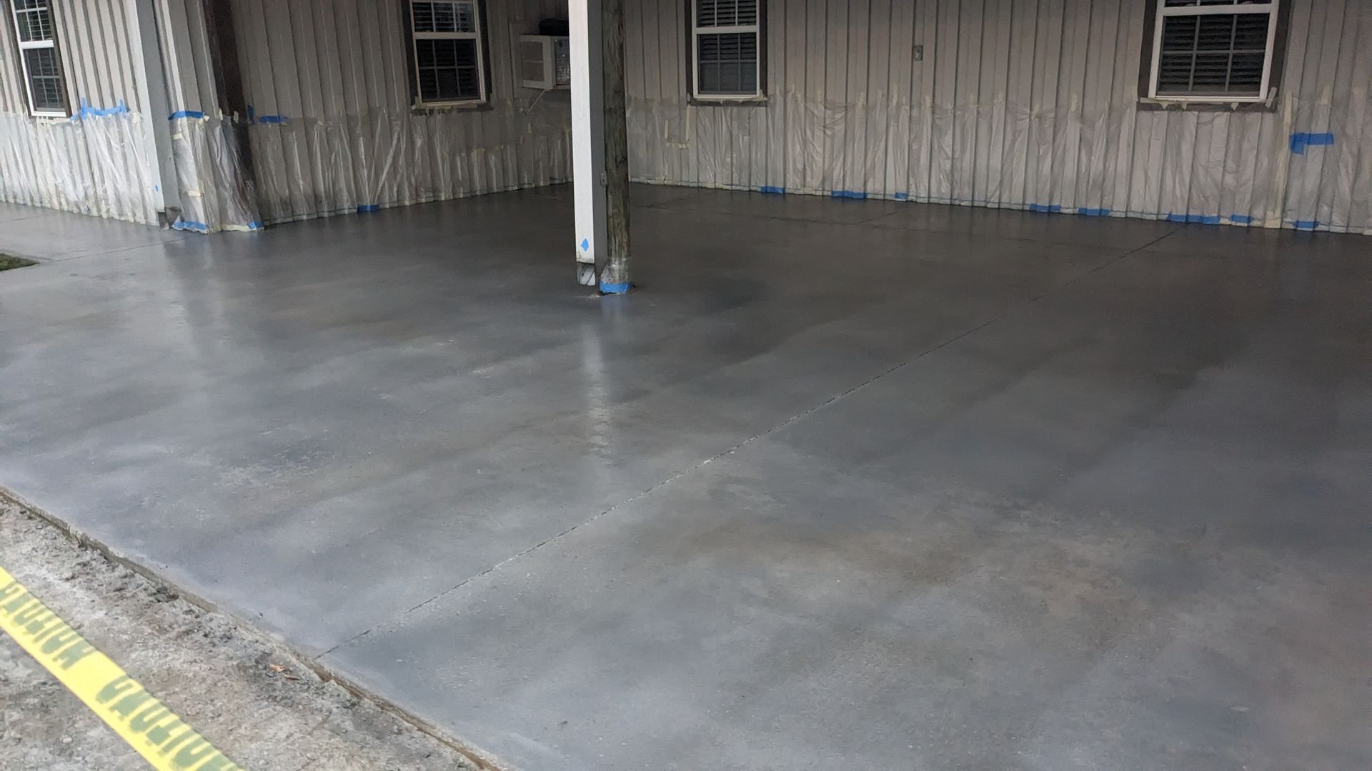a concrete driveway is being installed in front of a house .