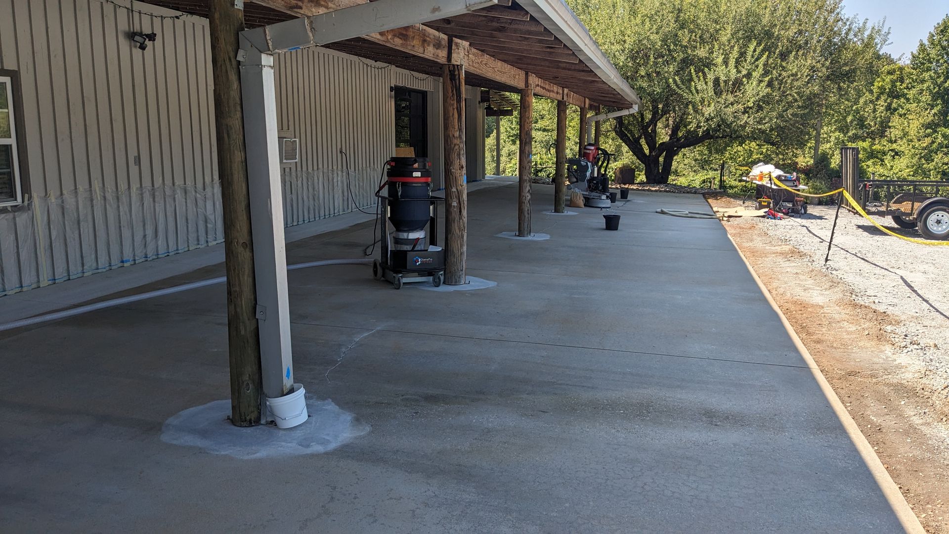A concrete patio is being built in front of a house.