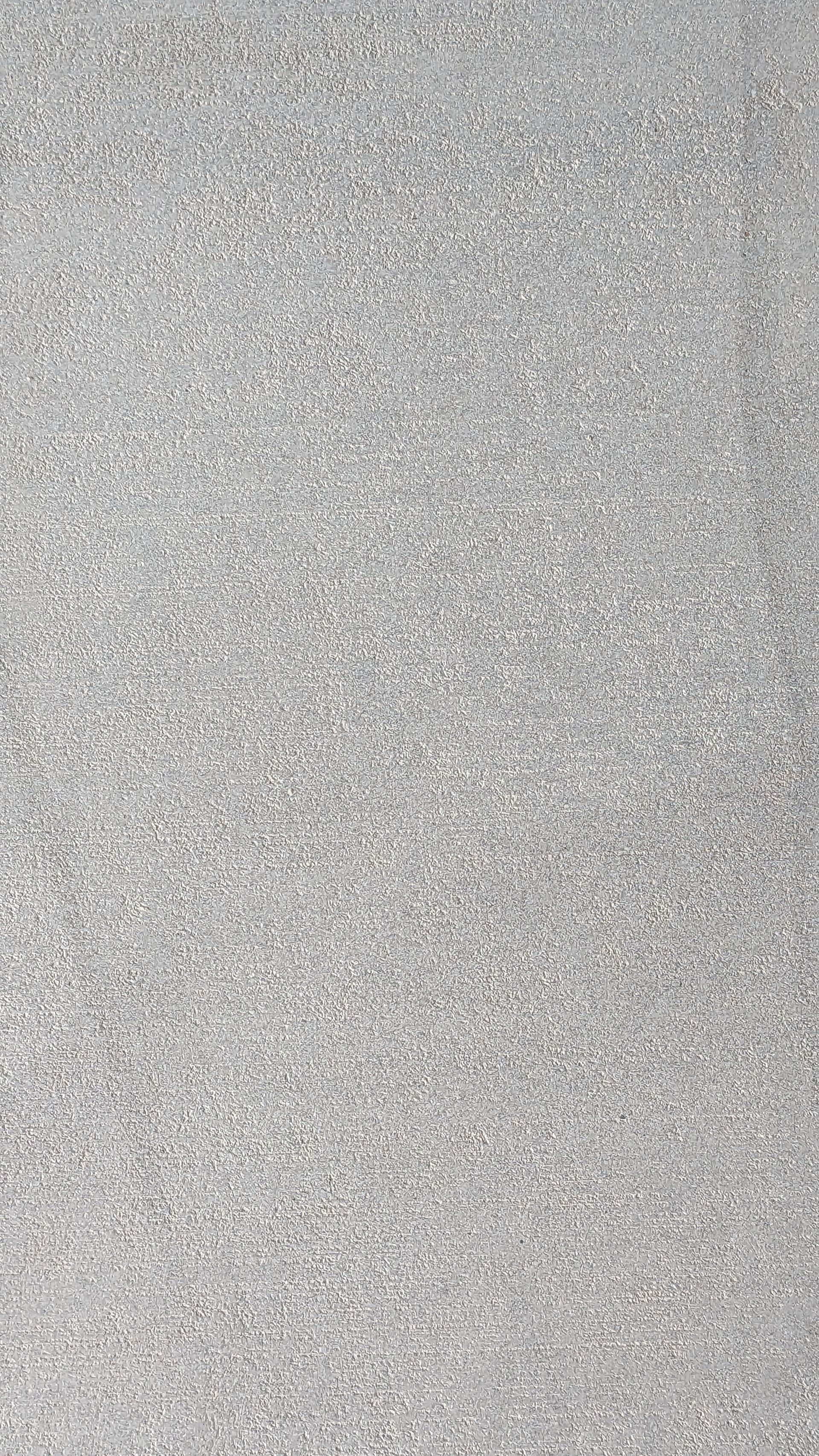 A close up of a gray carpet texture.