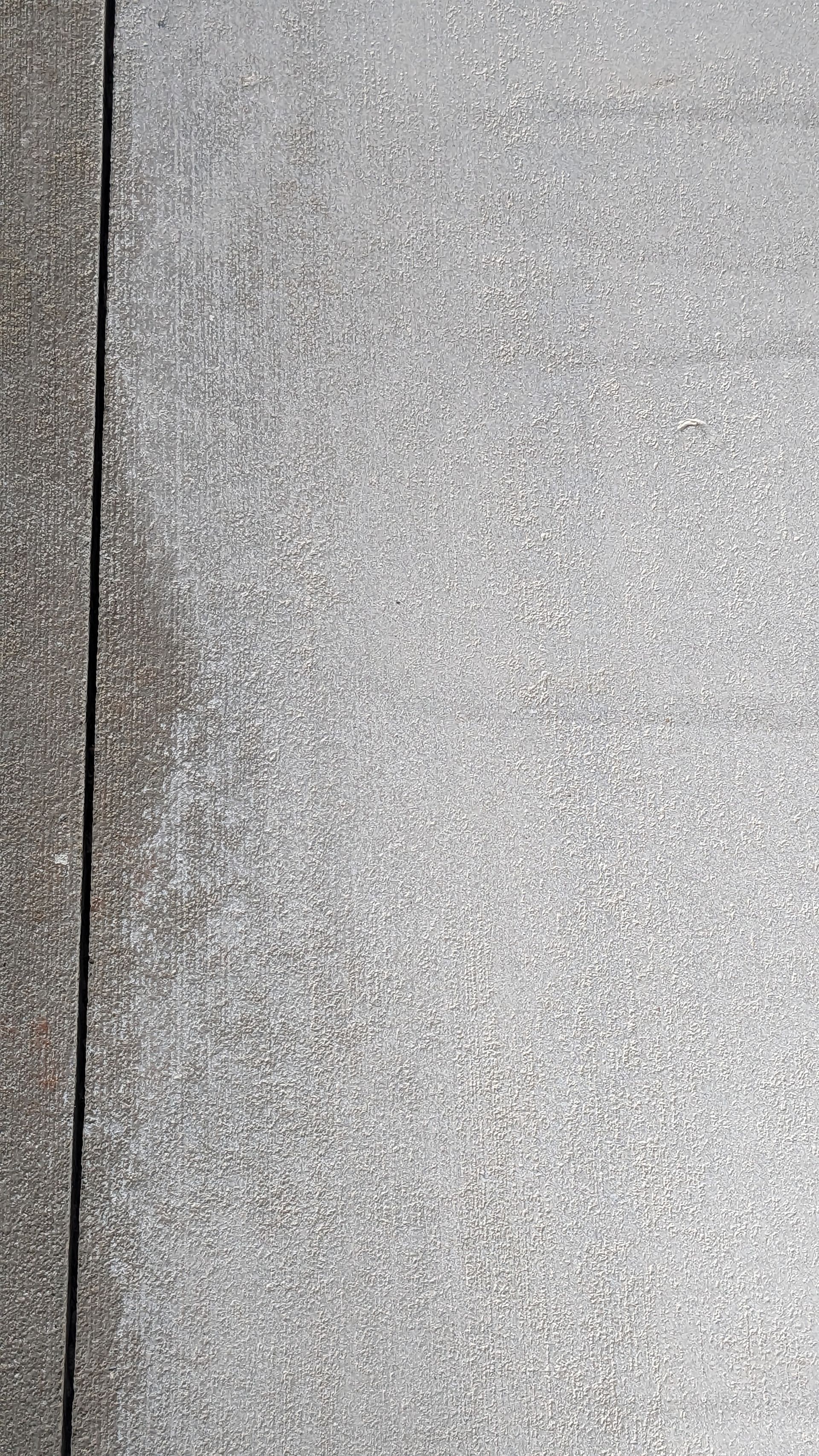 A close up of a metal surface with a grainy texture.