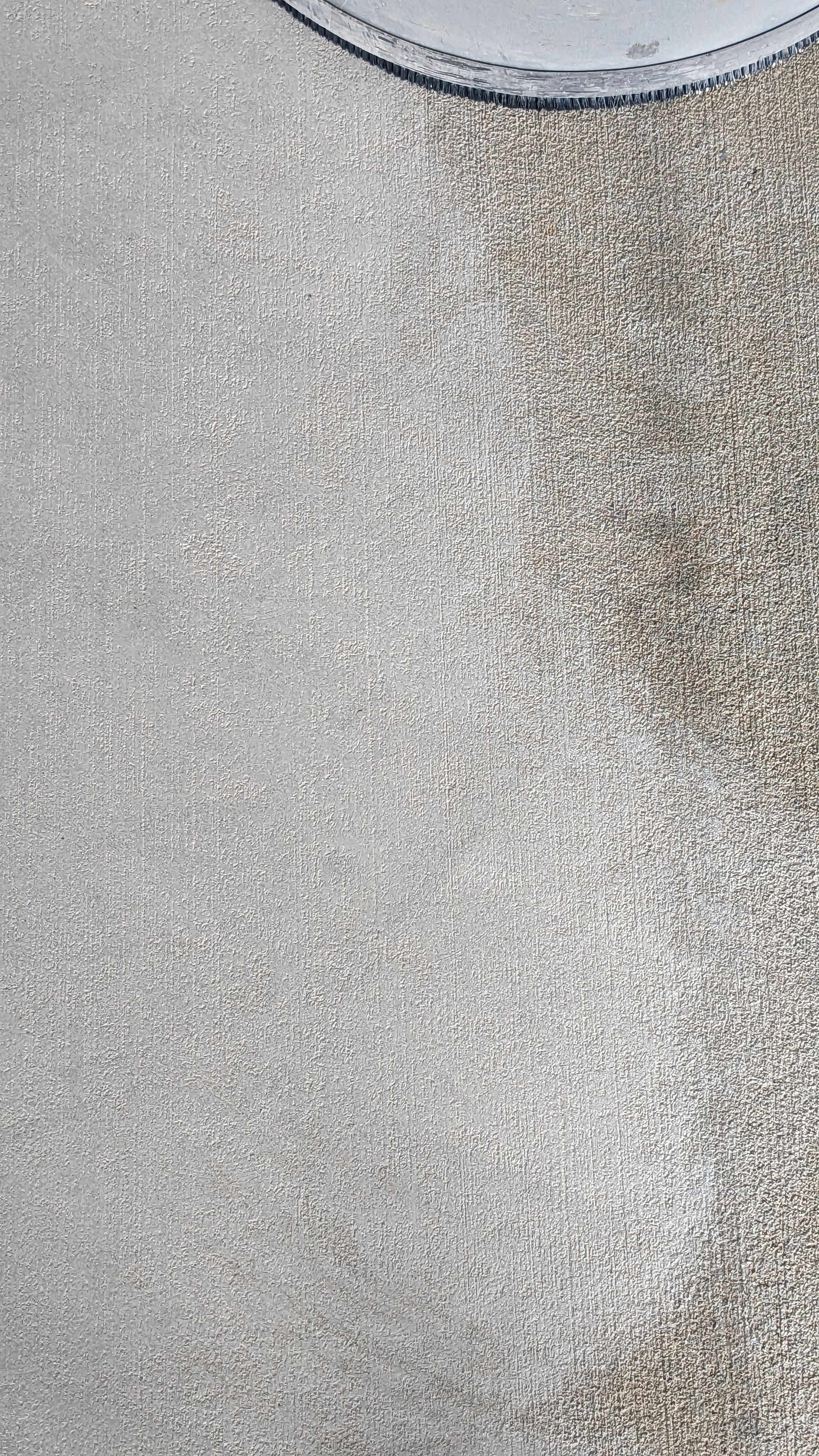 A close up of a carpet with a white border on a table.