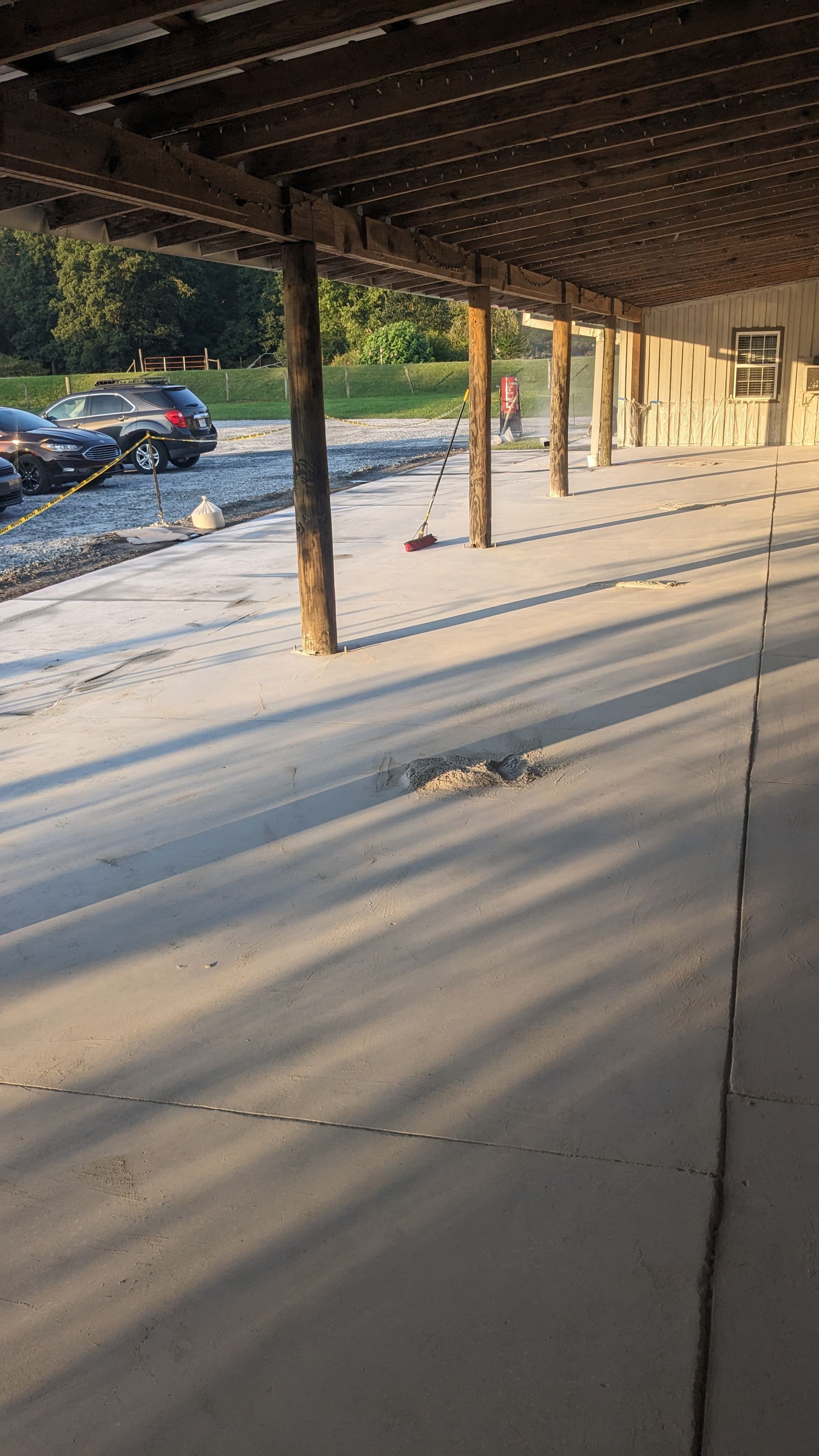A parking lot with cars parked under a covered area.