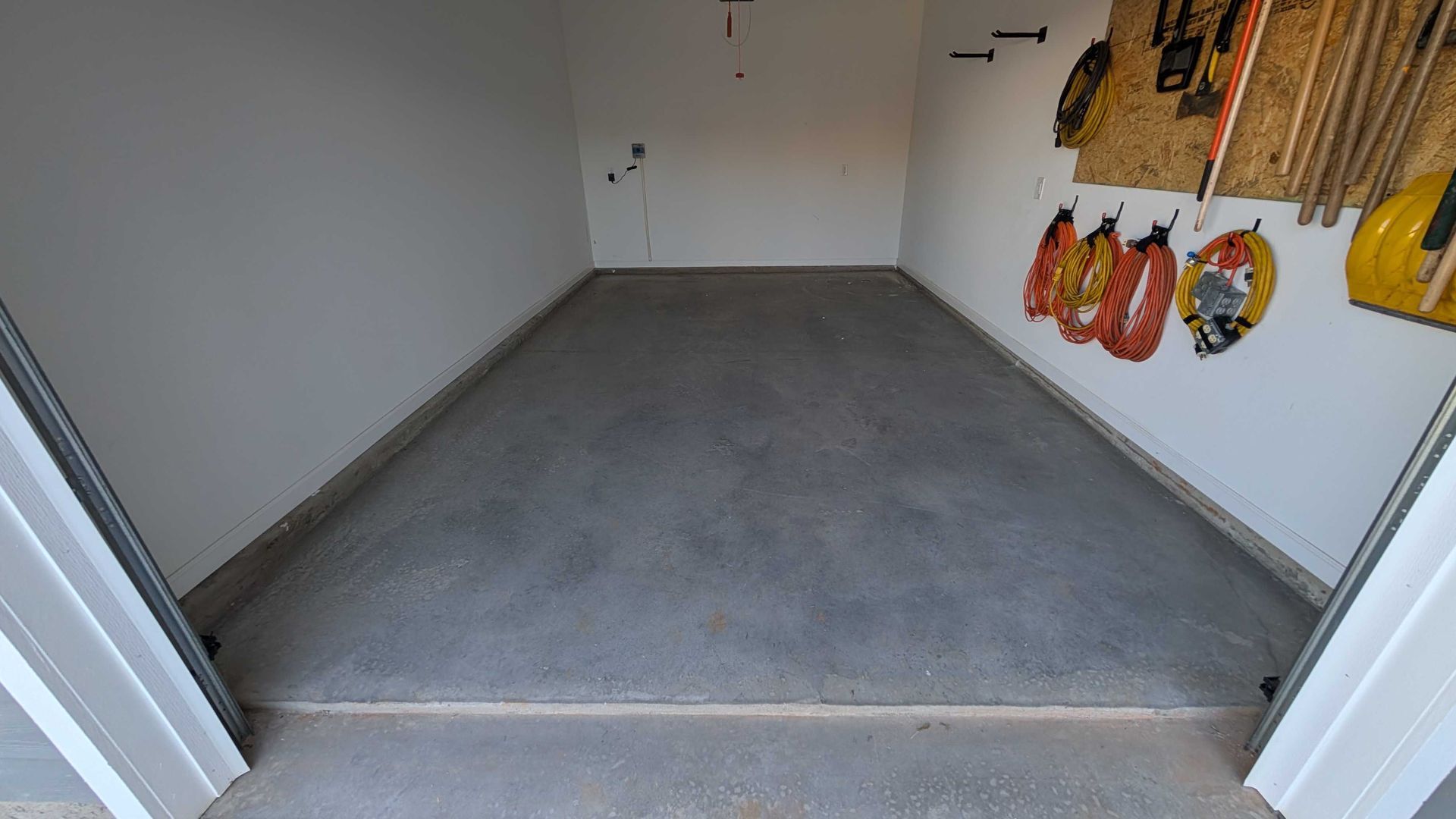 A garage with a lot of tools hanging on the wall