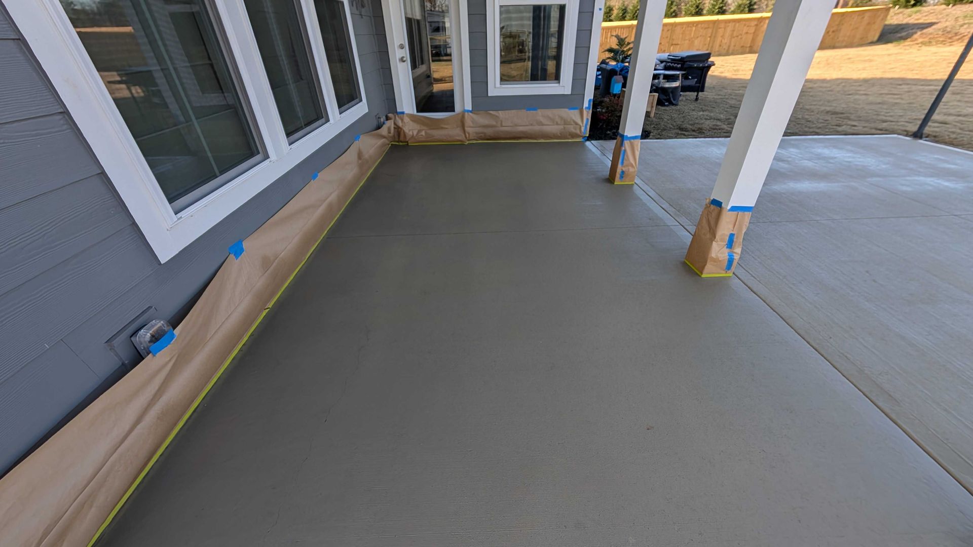 A concrete porch is being built in front of a house.