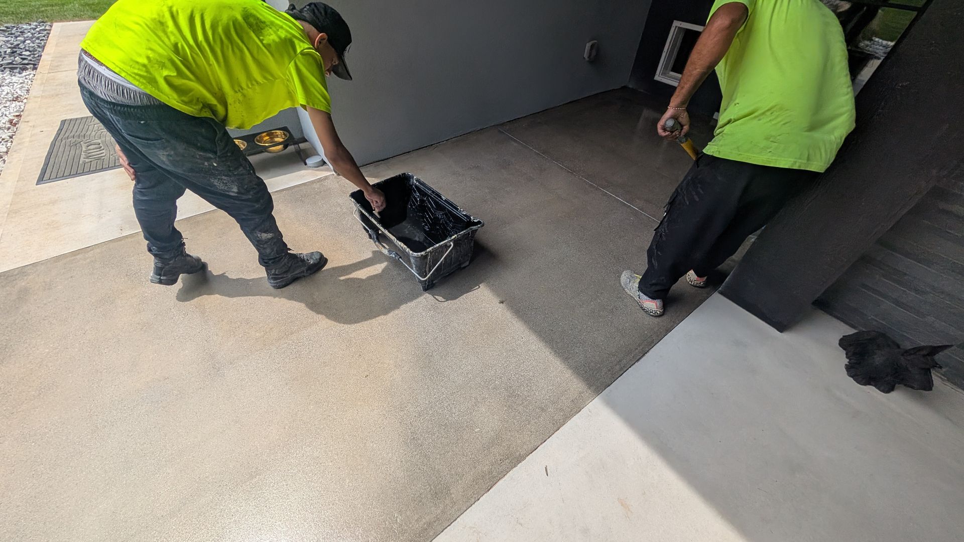 Team applying grind and seal finish on walkway installed by Zachary Daniel Concrete in Simpsonville, SC.