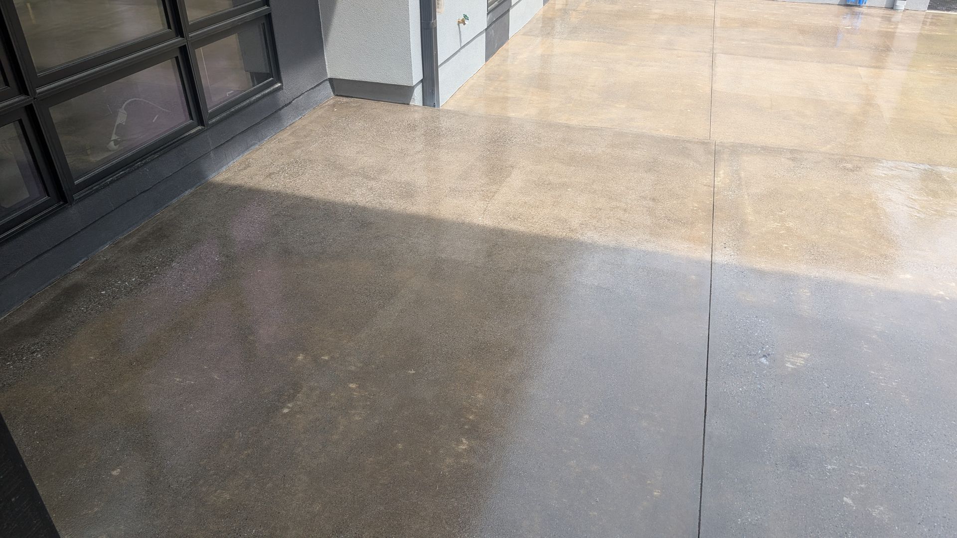 Sealed front patio with joint line pattern installed by Zachary Daniel Concrete in Dunean, SC.