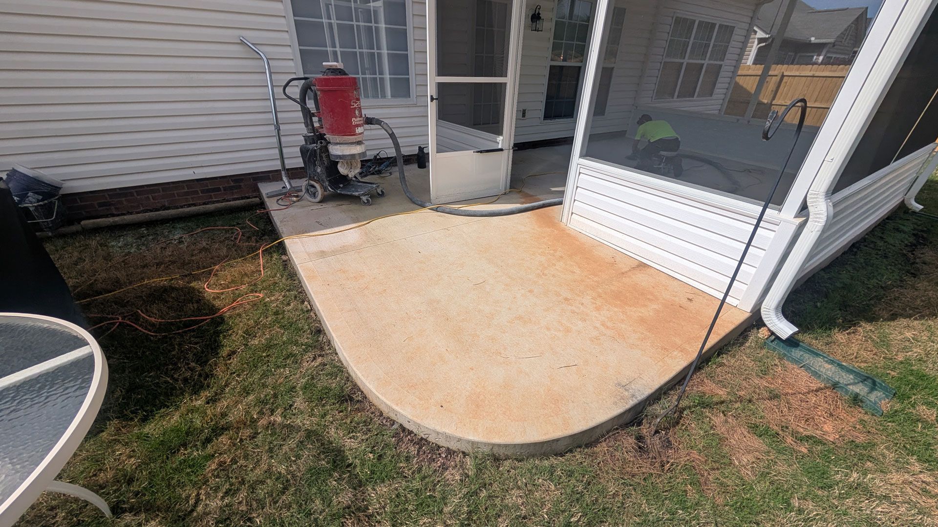 A lawn mower is sitting on top of a pile of sand.
