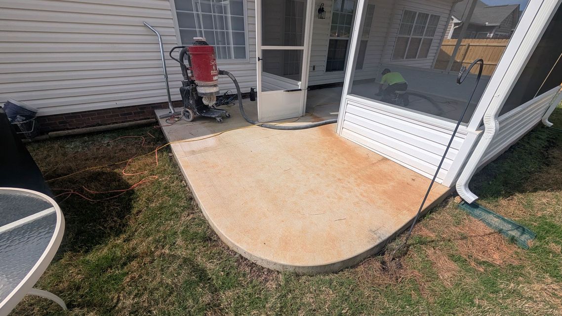 A lawn mower is sitting on top of a pile of sand.