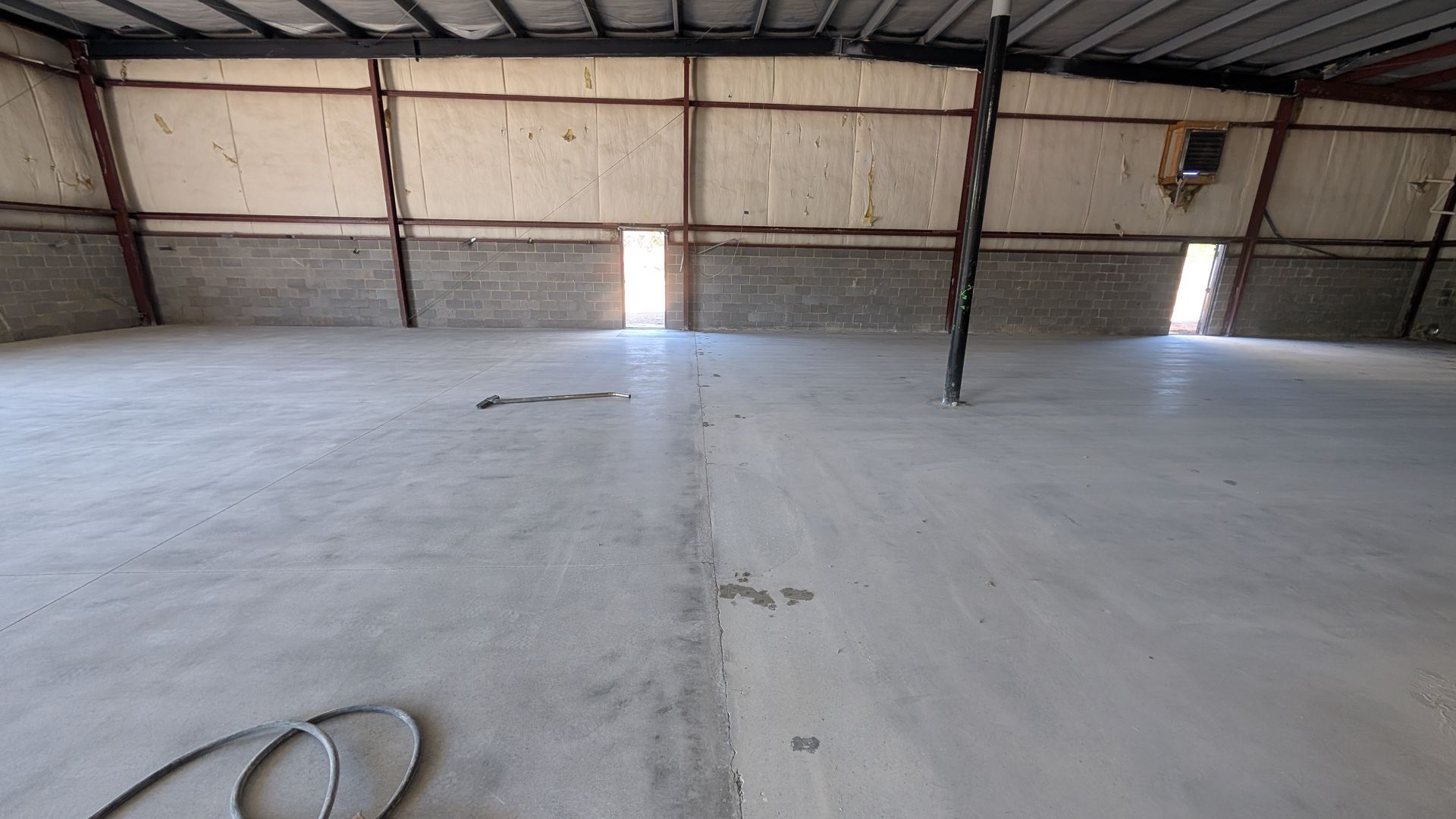 Hone Guard floor surface in progress across warehouse installed by Zachary Daniel Concrete in Arcadia, SC.