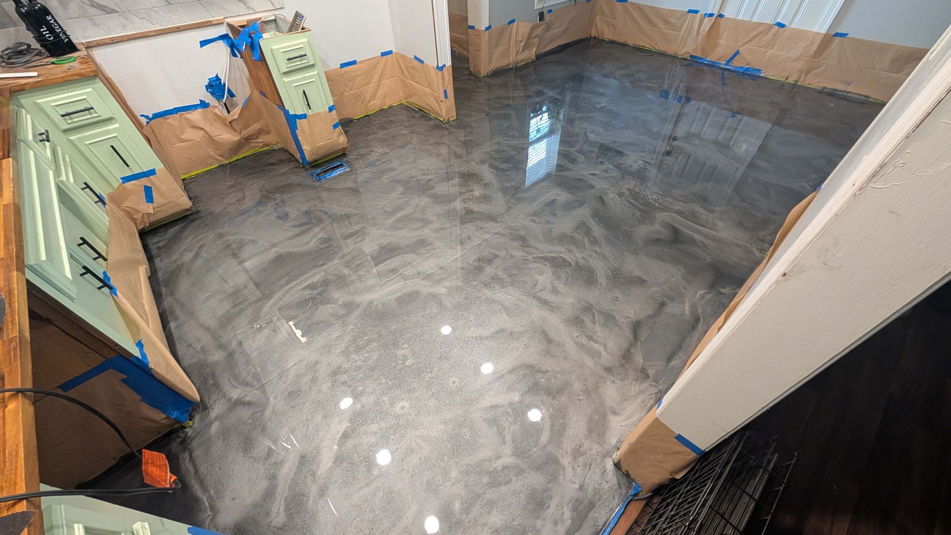 A room with a shiny metallic floor and stairs.