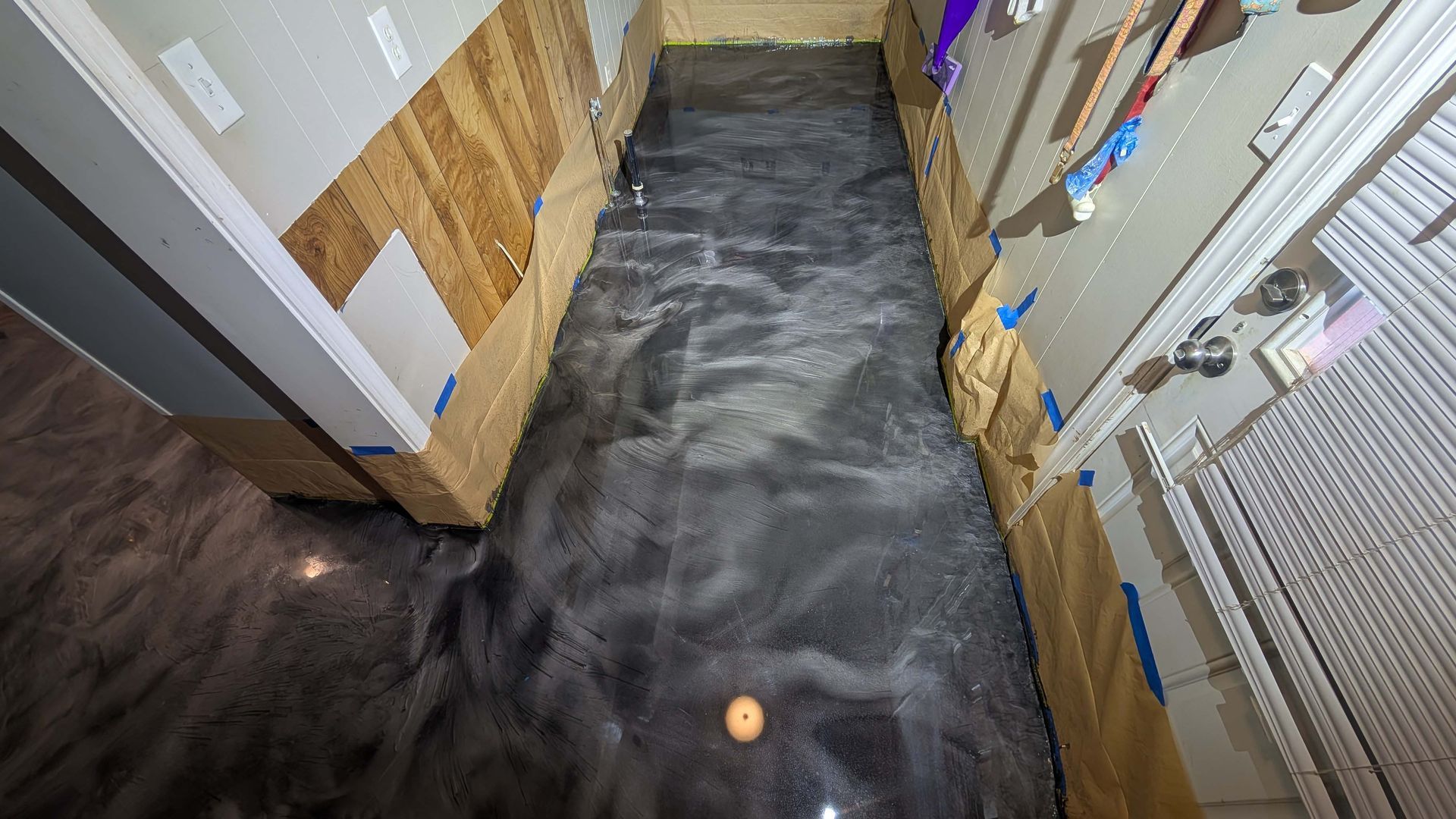 A hallway with a metallic floor in a house.