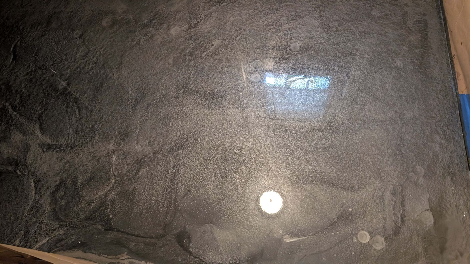 A pile of sand is sitting on a table with a light shining through it.