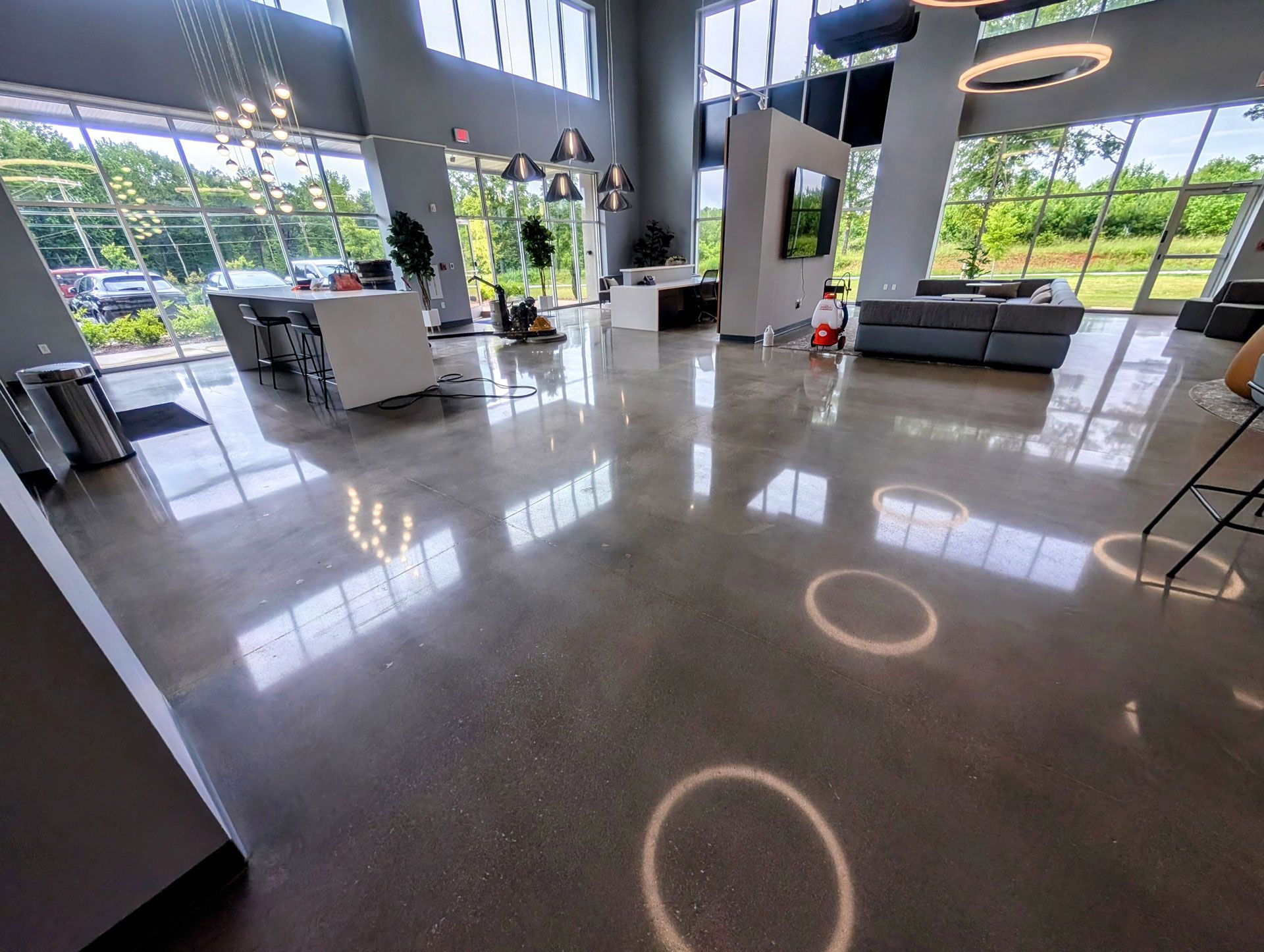 Polished concrete floor in a modern lobby with large window in Greenville, SC.