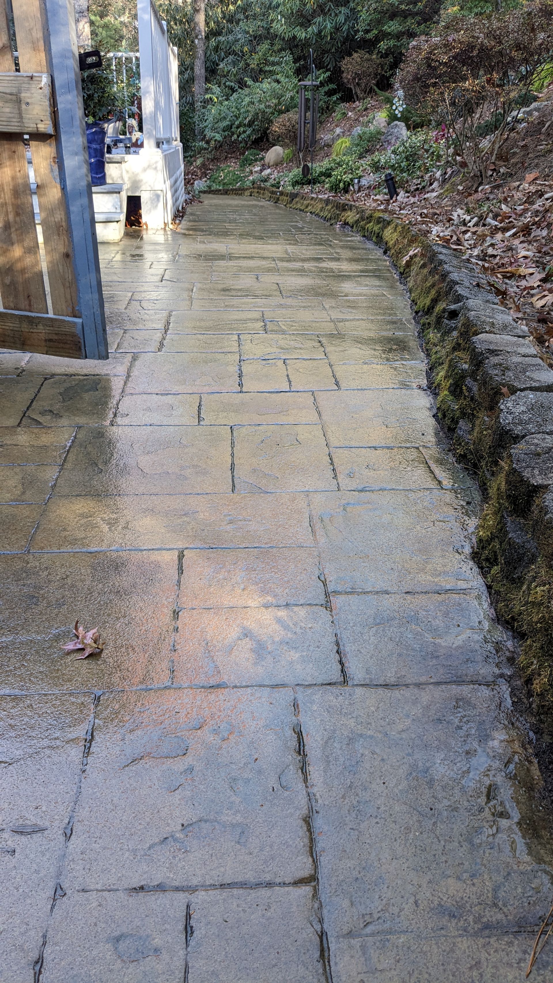 A brick walkway leading to a building in a park.