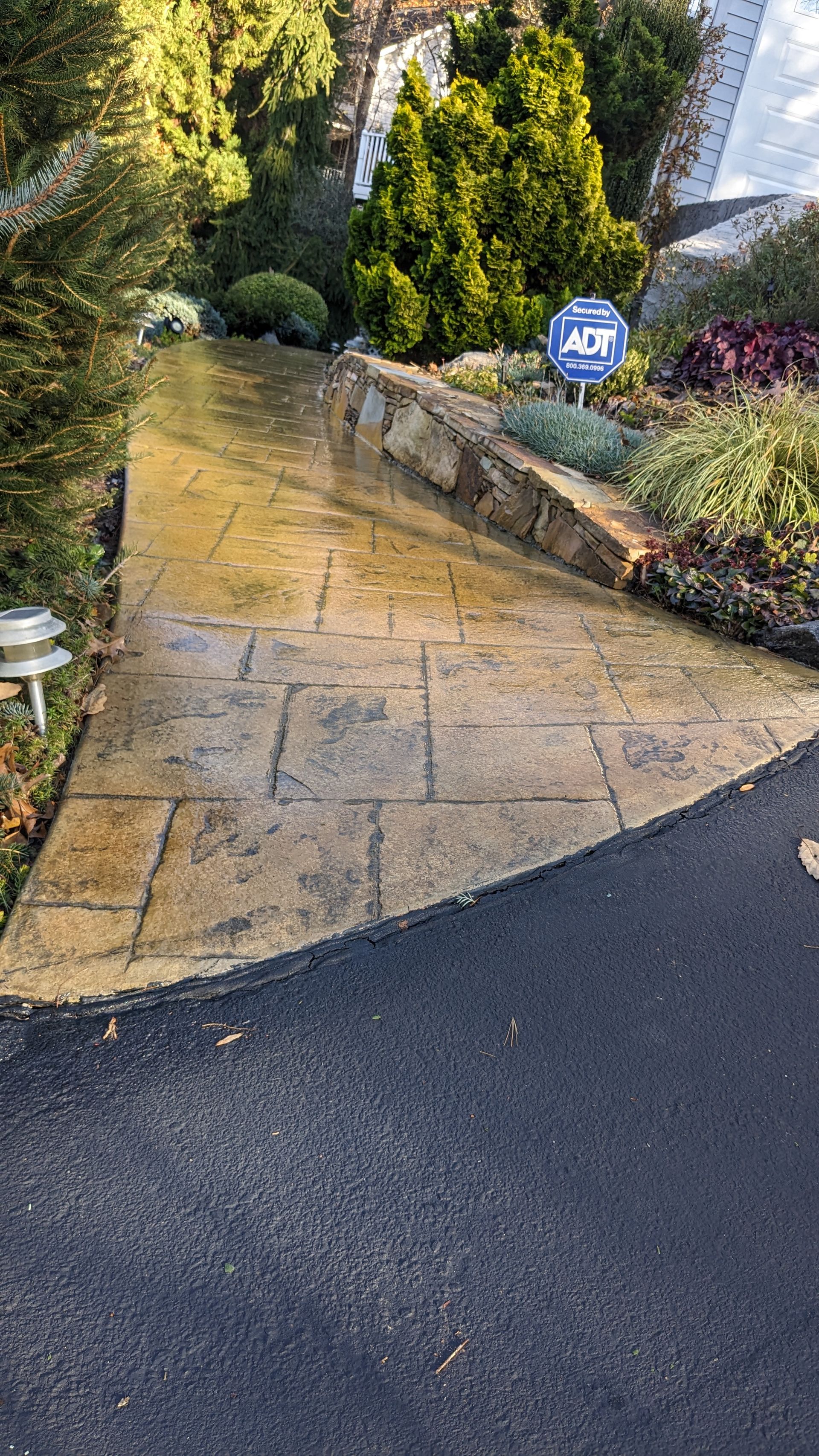 A concrete walkway with a handicap sign on the side of it.