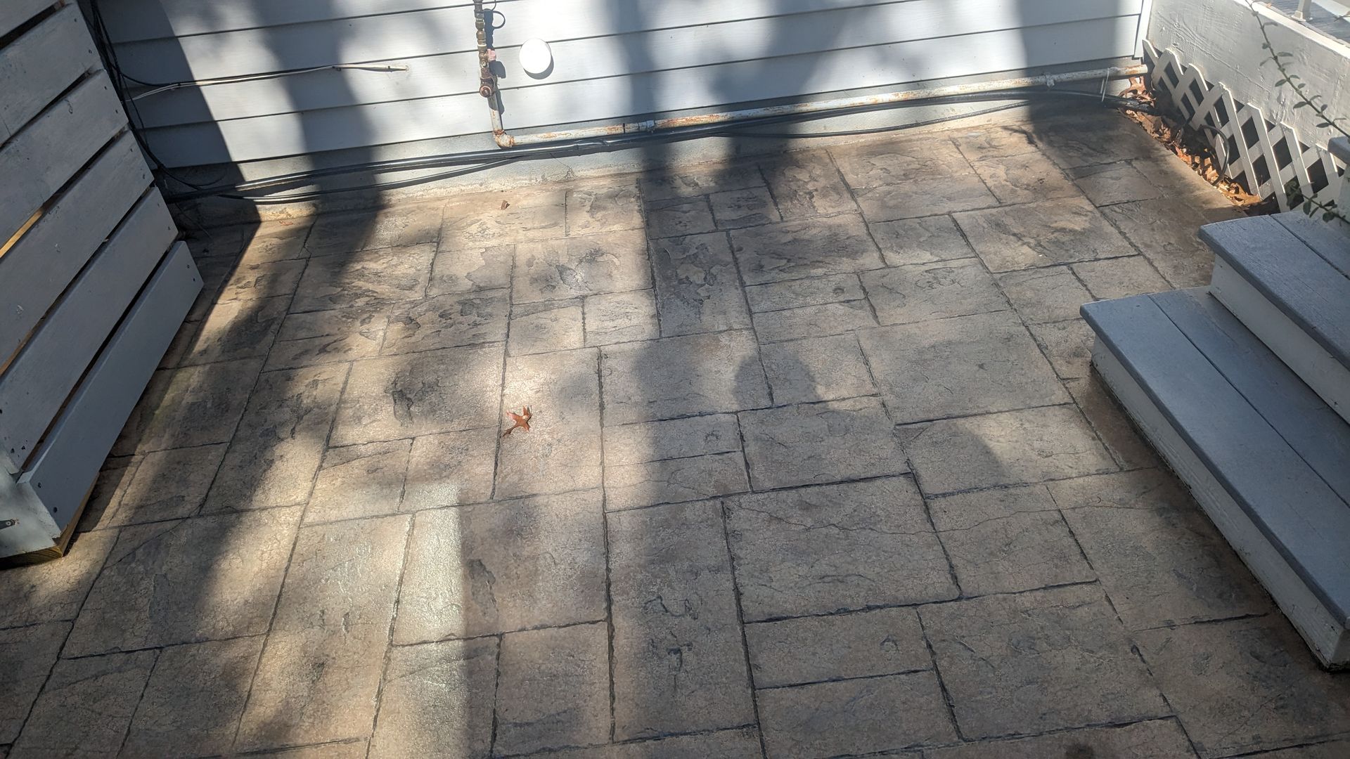 A brick patio with stairs leading up to it