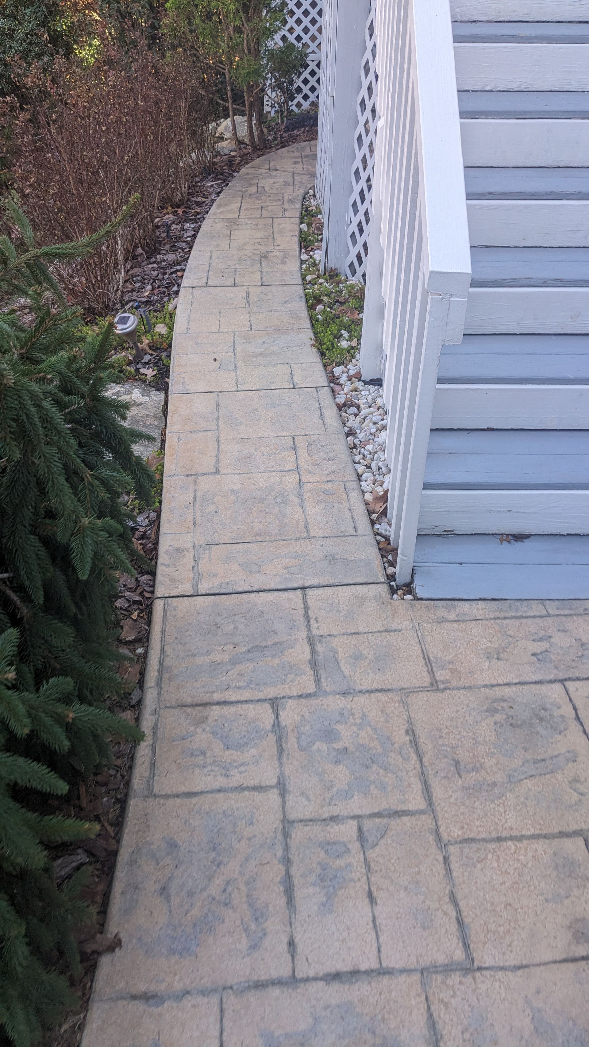 A stone walkway leading to a set of stairs.