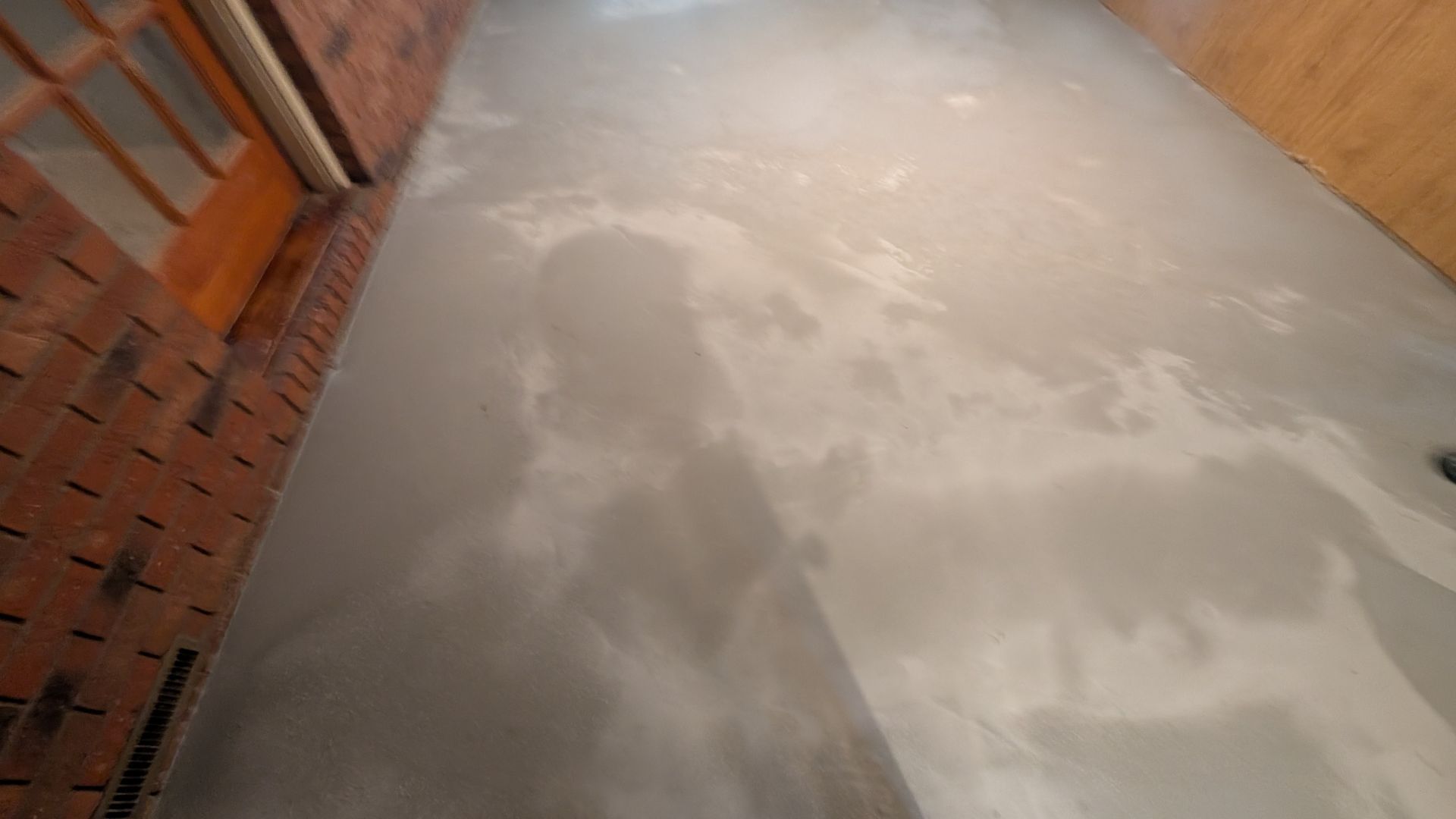 Fresh overlay surface smoothing uneven plywood floor installed by Zachary Daniel Concrete in Arial, SC.