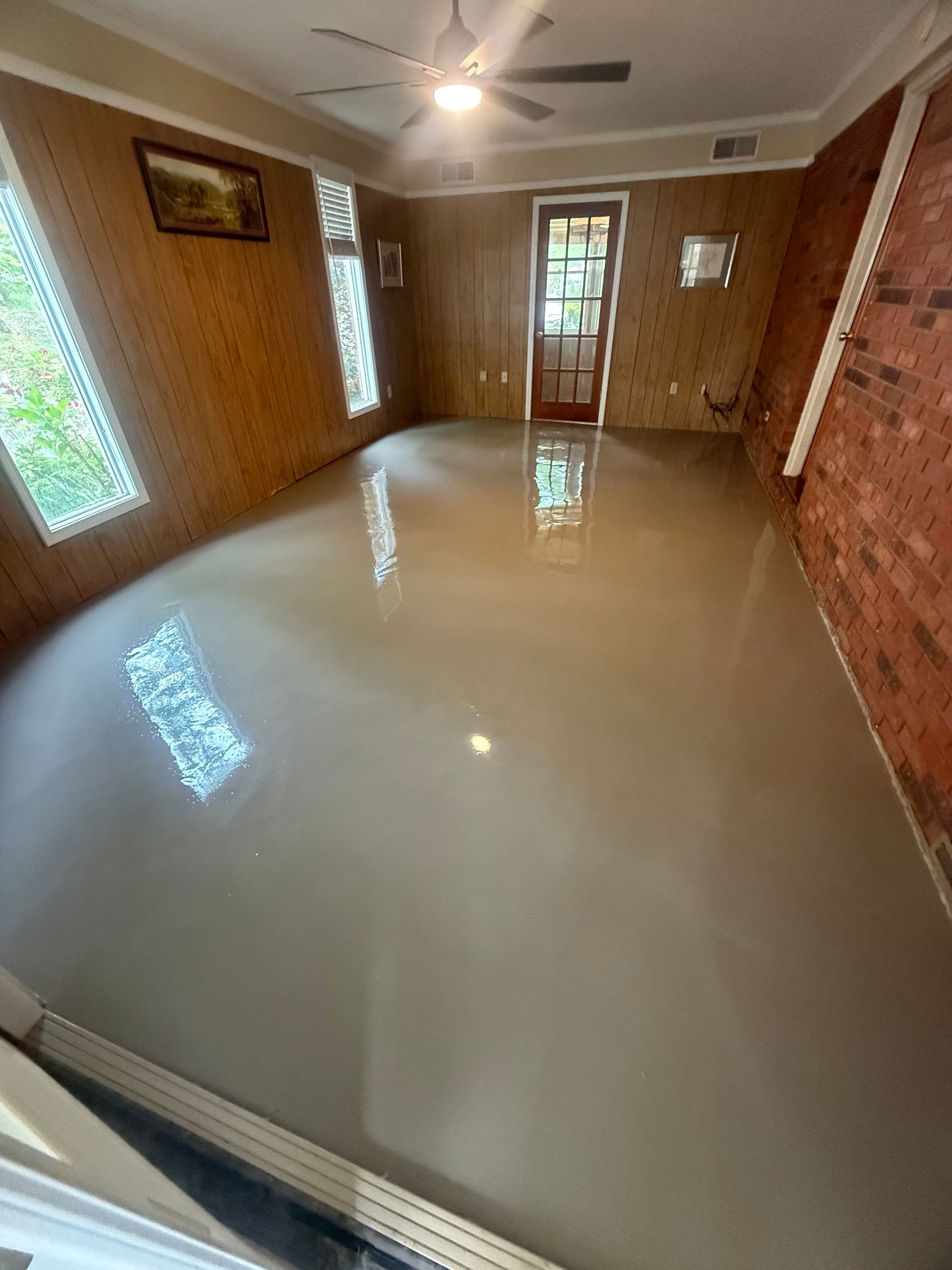 High-gloss overlay finish curing across full room installed by Zachary Daniel Concrete in Easley, SC.