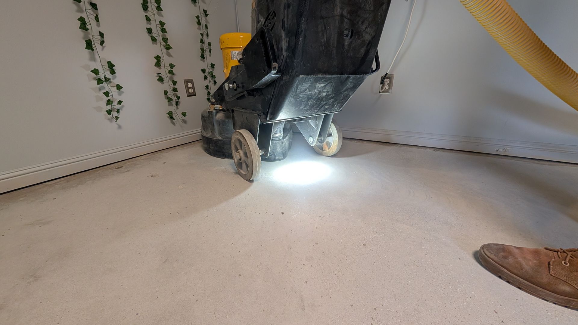 A person is using a machine to clean a carpet in a room.