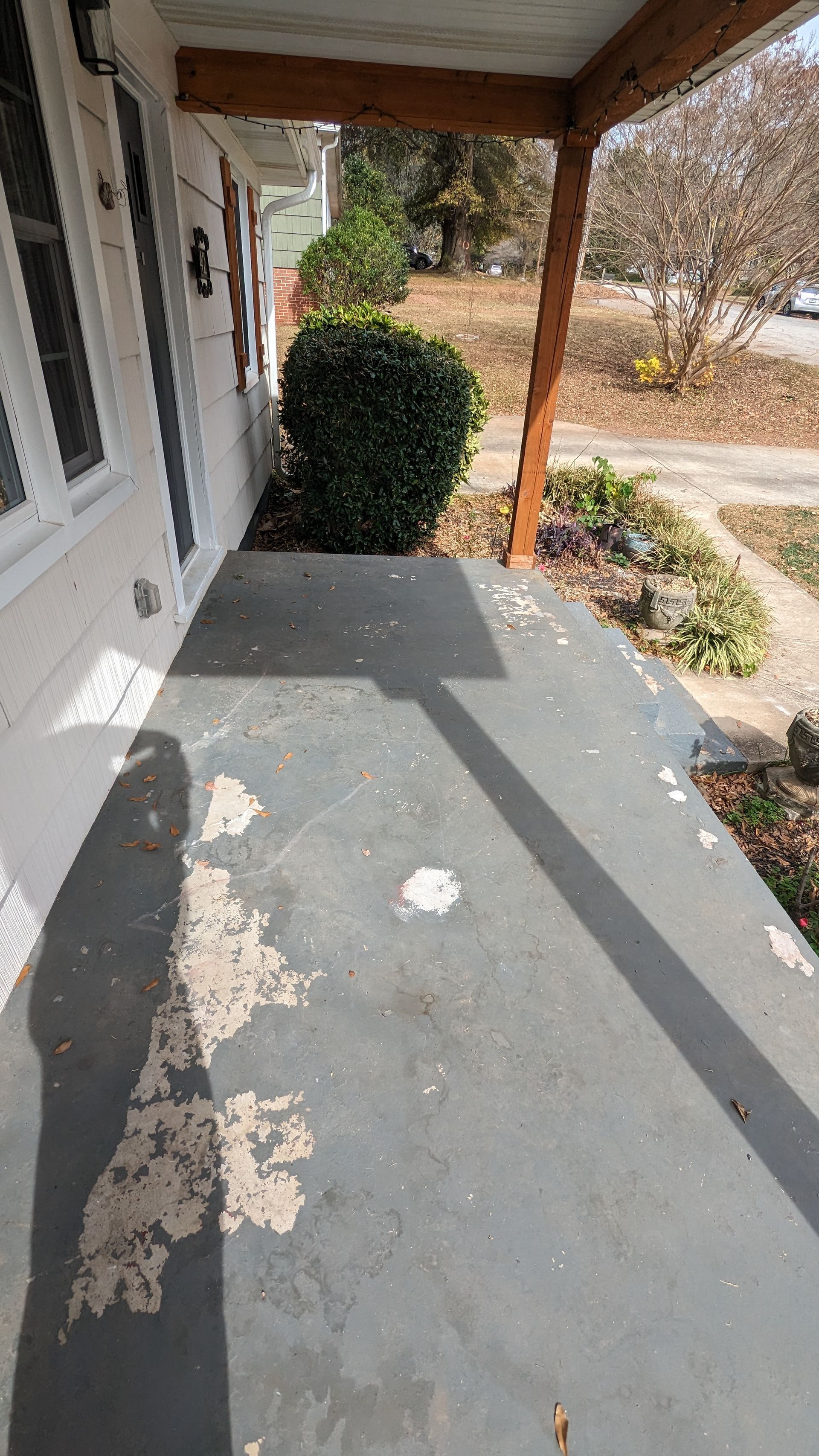 A porch with a shadow of a person on it.