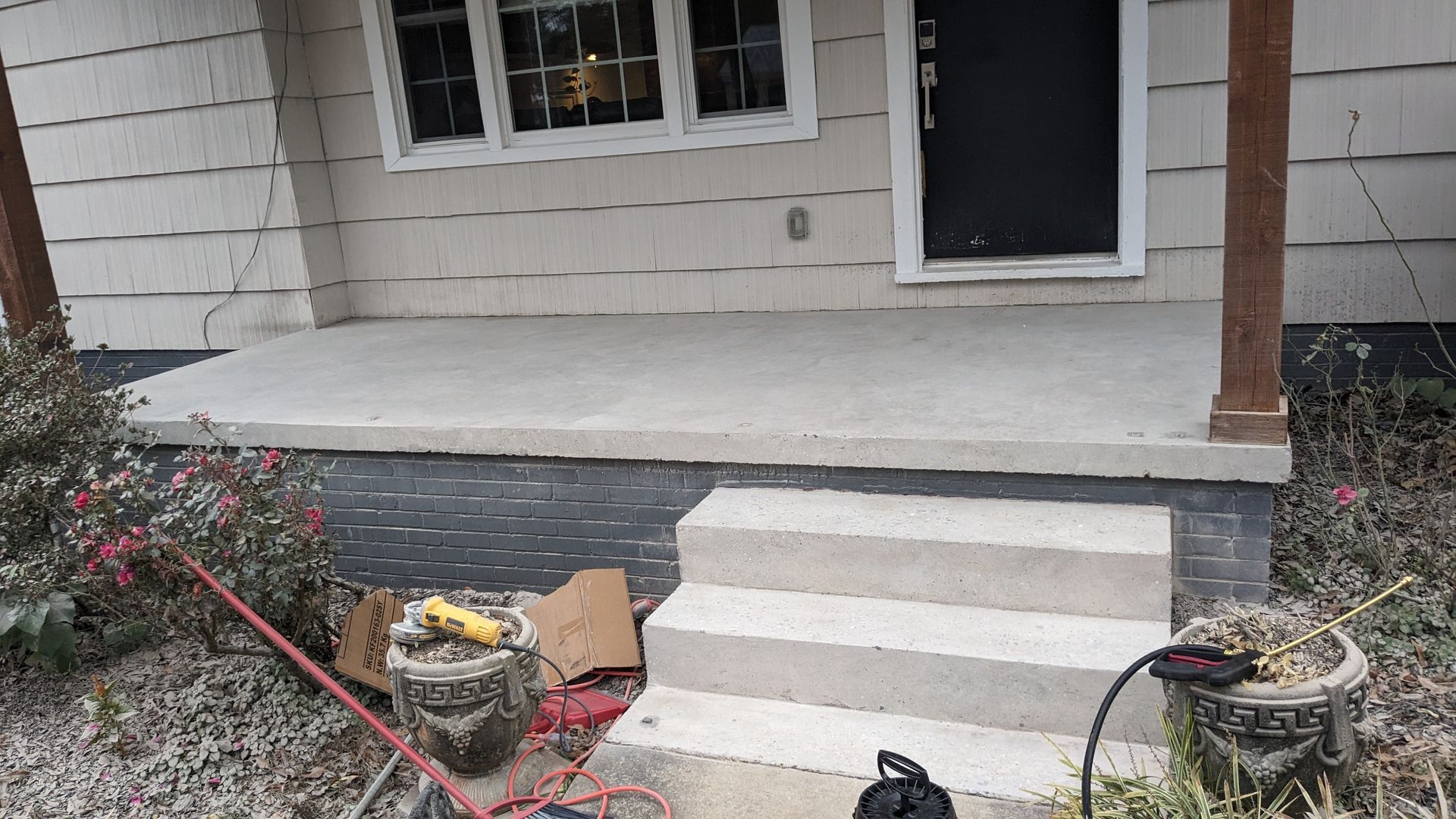 A house with a porch and stairs is being remodeled.