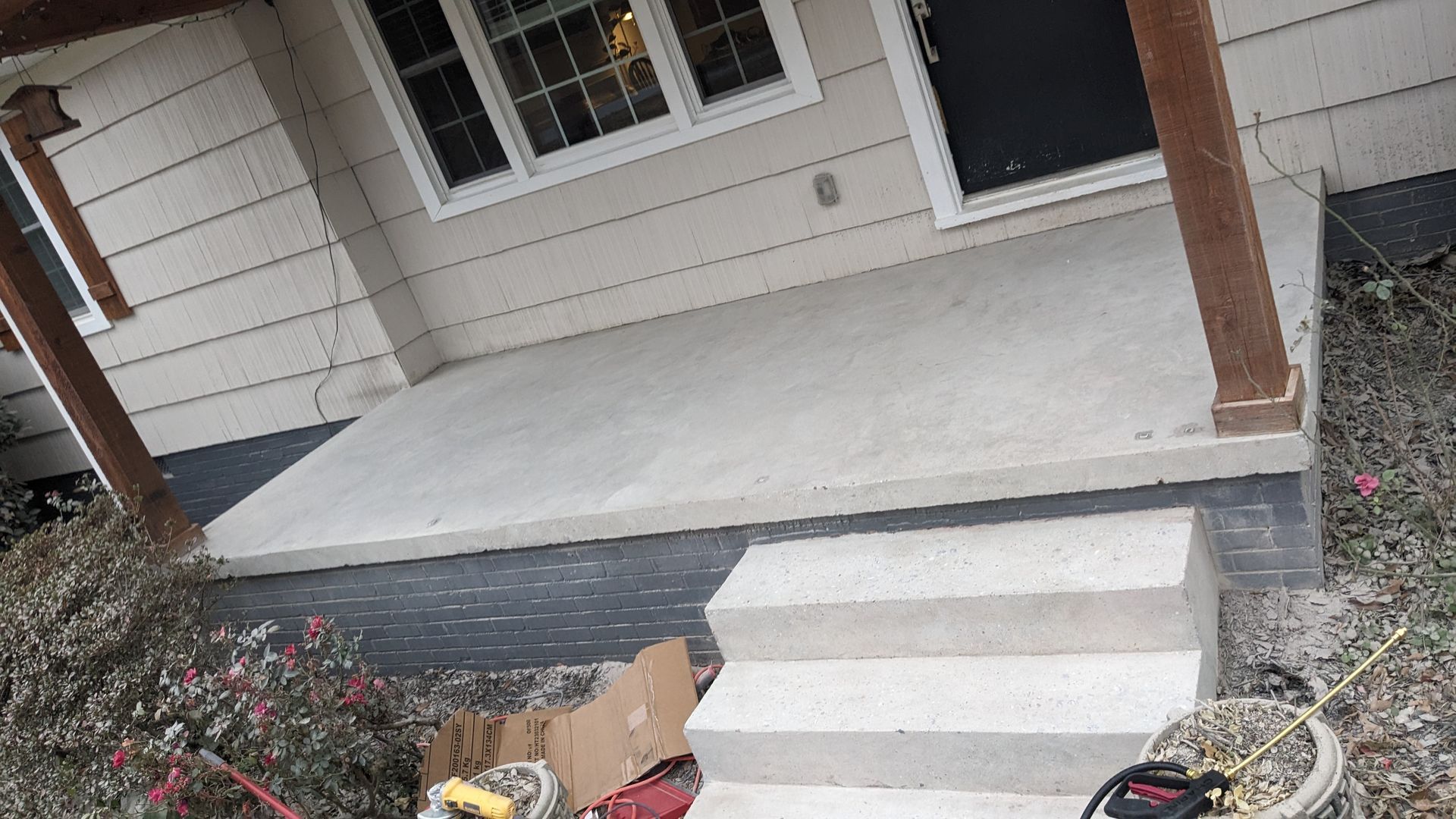 A house with a porch and stairs is being remodeled.