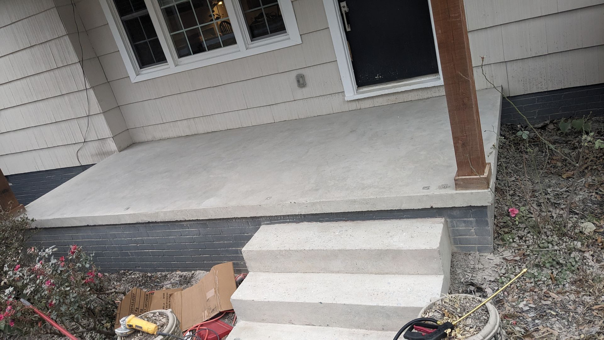 The front porch of a house is being remodeled.