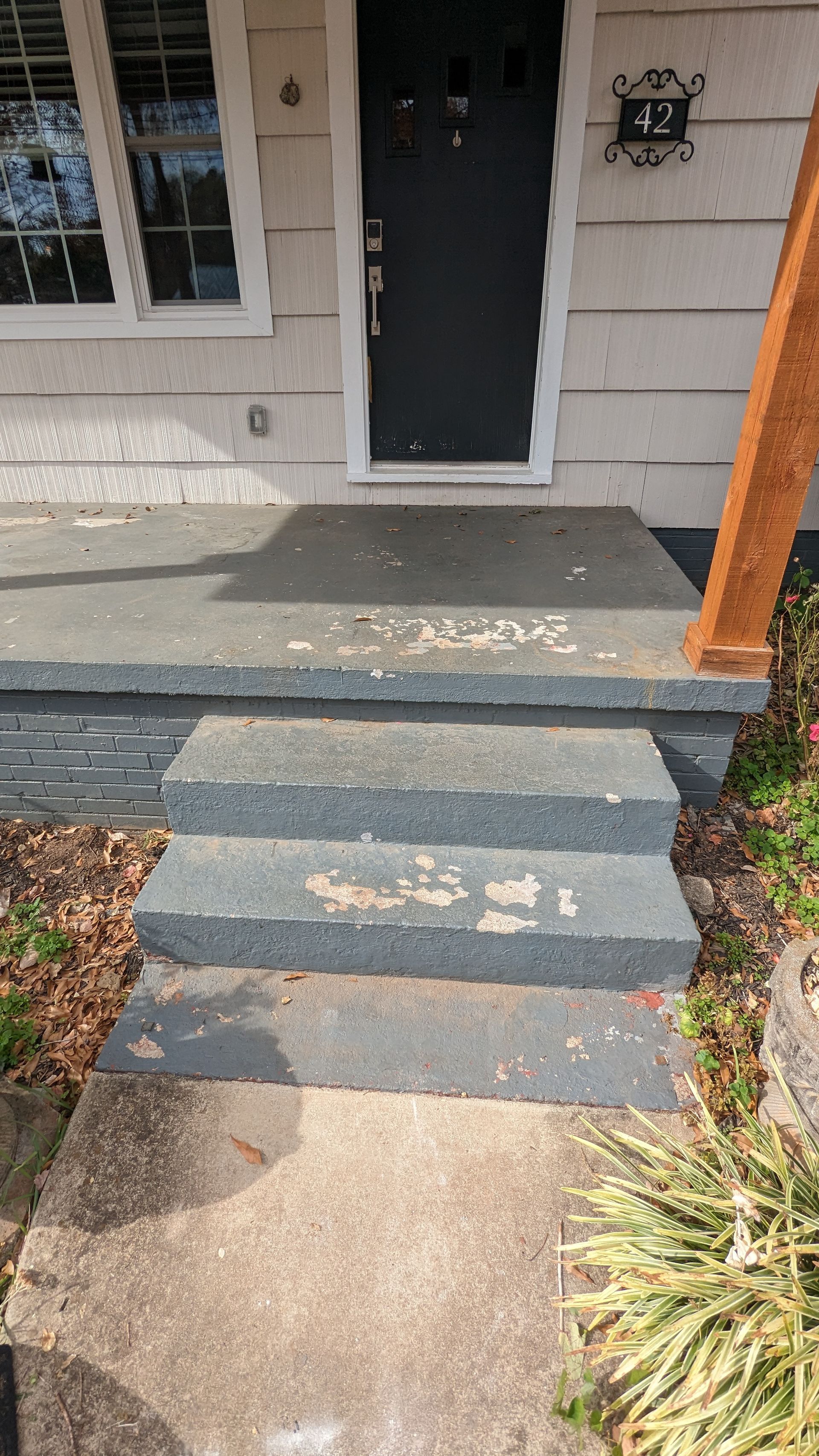 A staircase leading up to the front door of a house.