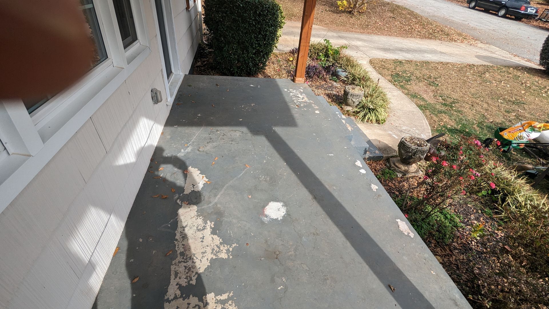 A person is standing on a porch of a house.