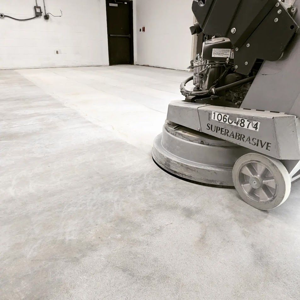 A machine is polishing a concrete floor in a room.