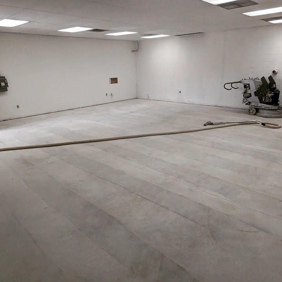 A large room with a concrete floor and white walls
