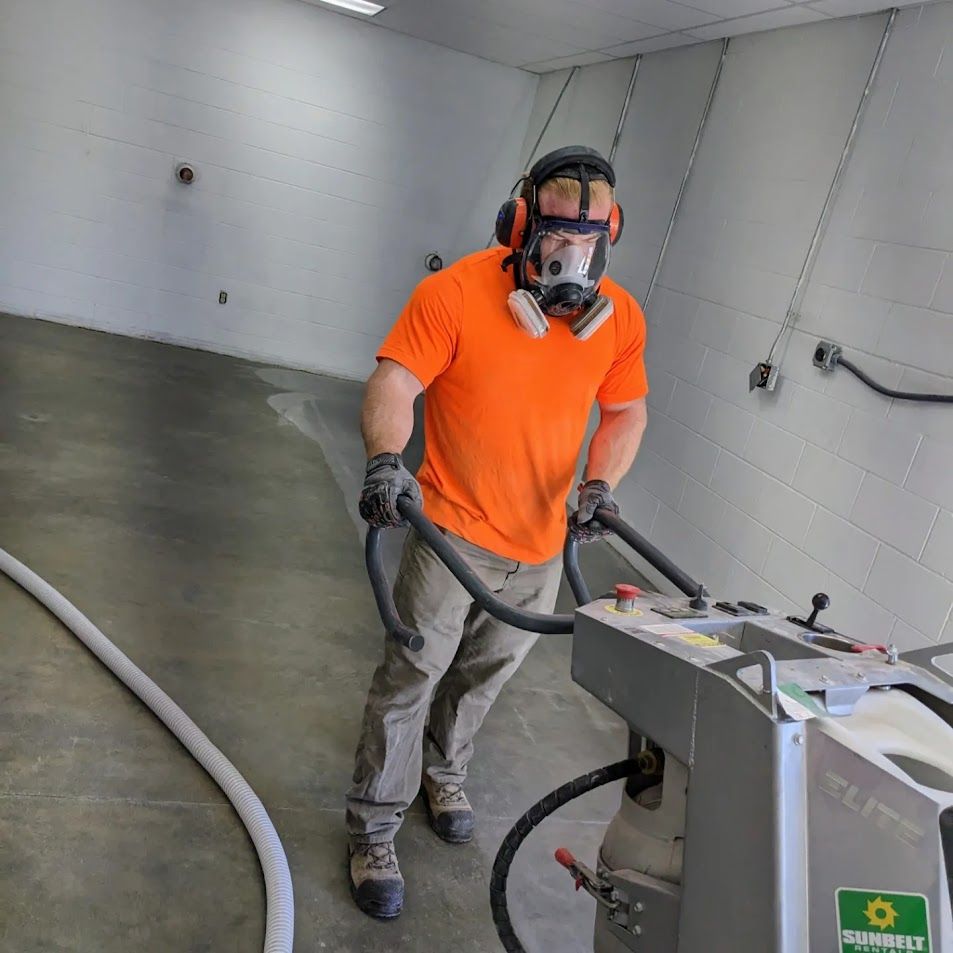 A man wearing a gas mask and headphones is pushing a machine