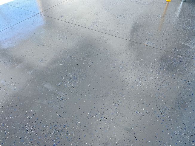 A gray floor with a lot of small dots on it