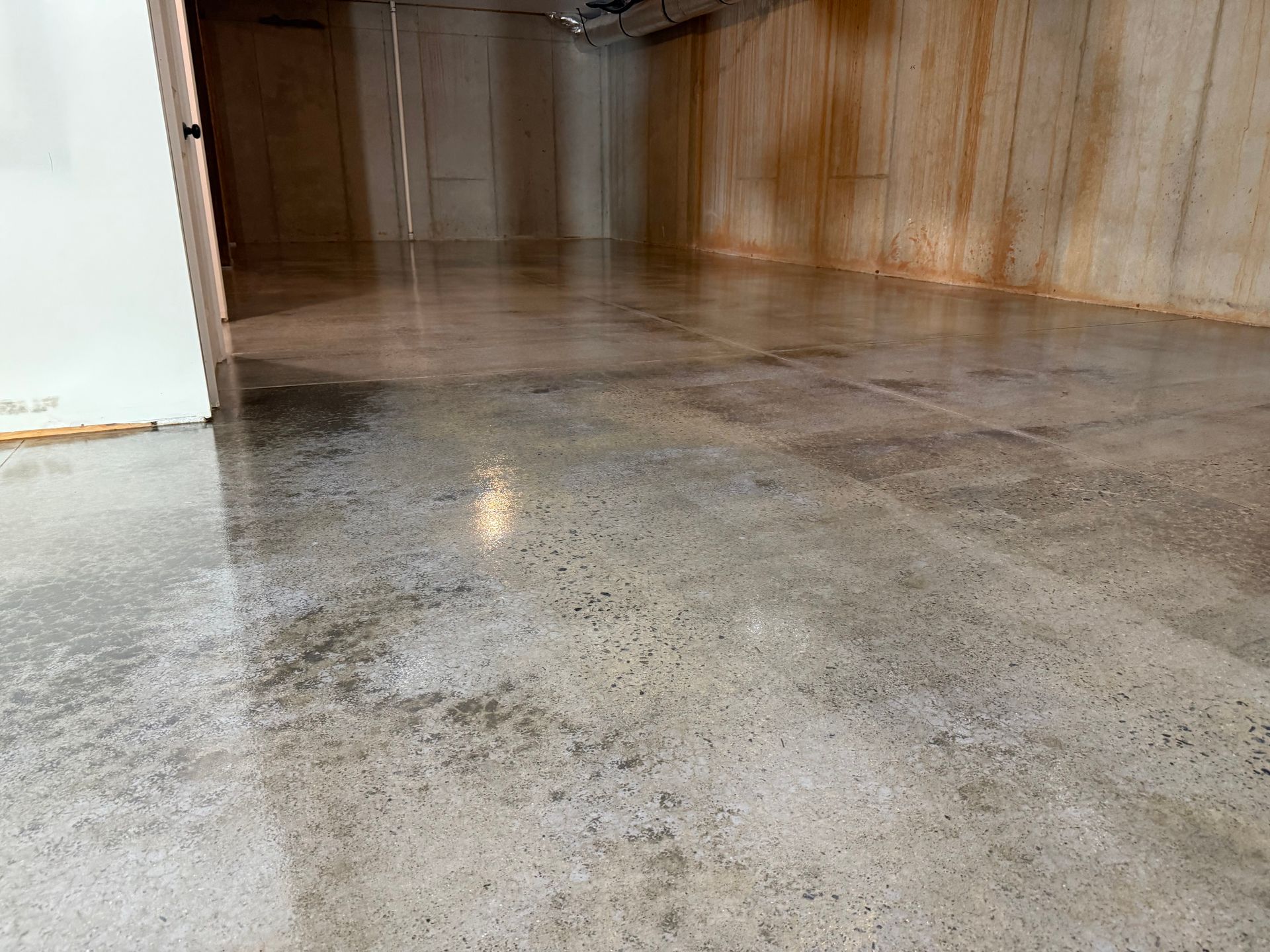 Reflective sealed concrete in open basement area installed by Zachary Daniel Concrete in Liberty, SC.