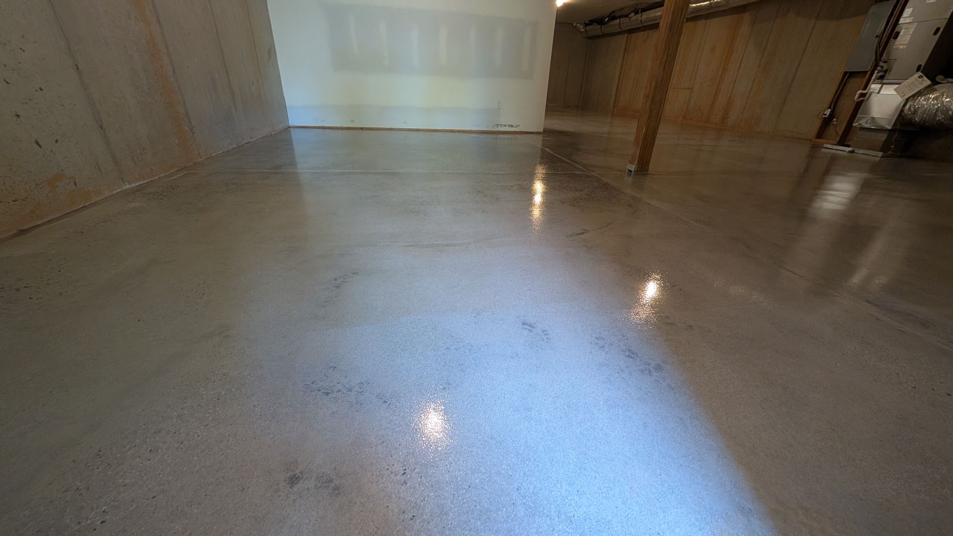 Glossy grind and seal concrete reflecting ceiling lights installed by Zachary Daniel Concrete in Pelzer, SC.