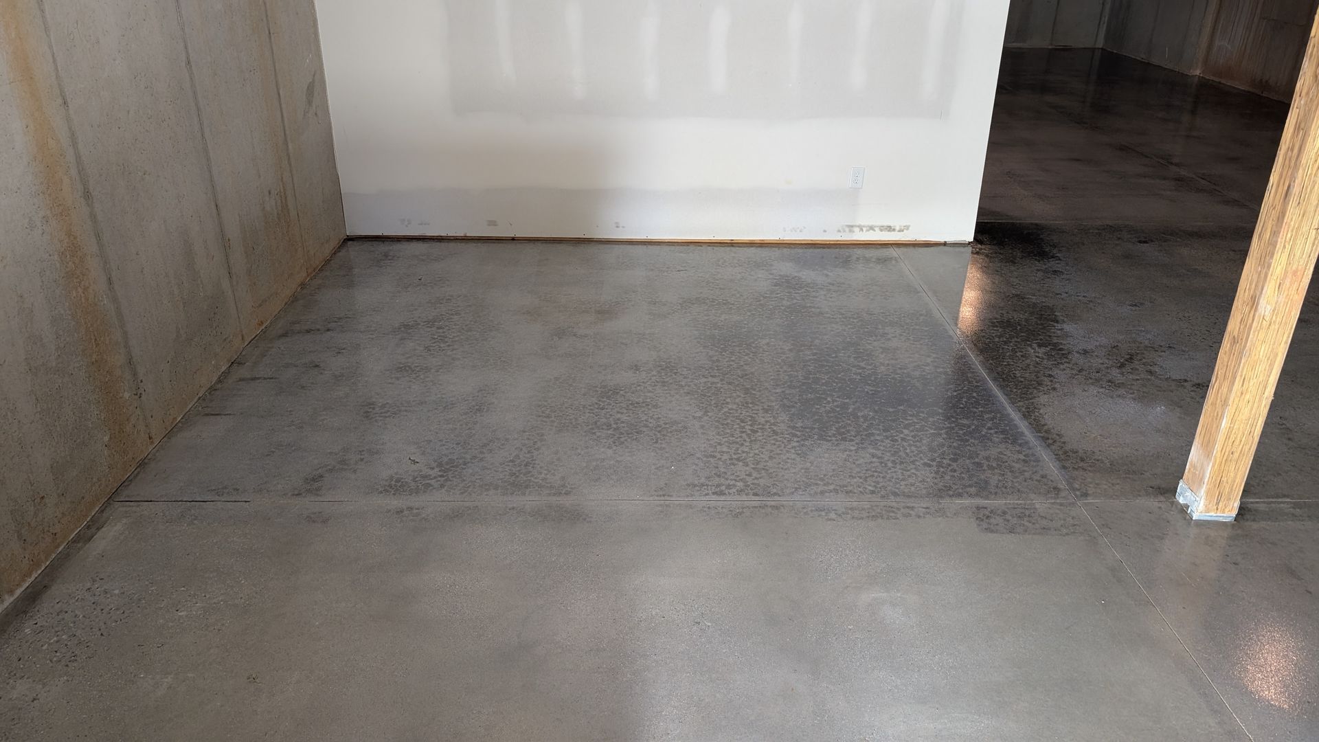 Dark-toned sealed floor with clean wall cut-ins installed by Zachary Daniel Concrete in Six Mile, SC.