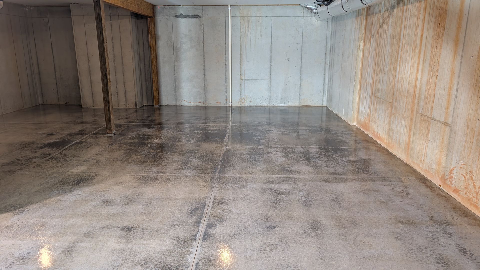 Glossy grind and seal finish in unfinished basement installed by Zachary Daniel Concrete in Arial, SC.