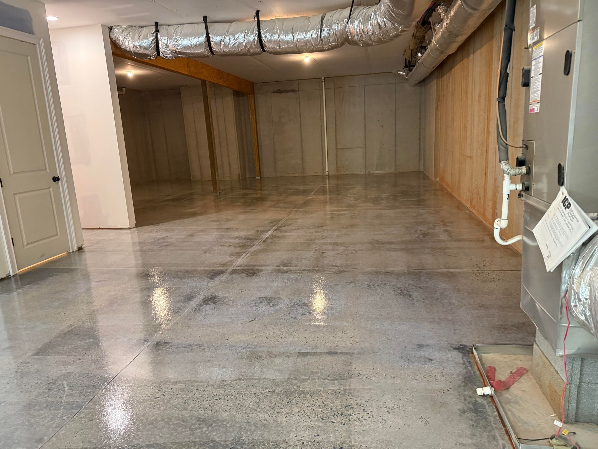 Indoor grind and seal basement floor in progress installed by Zachary Daniel Concrete in Easley, SC.