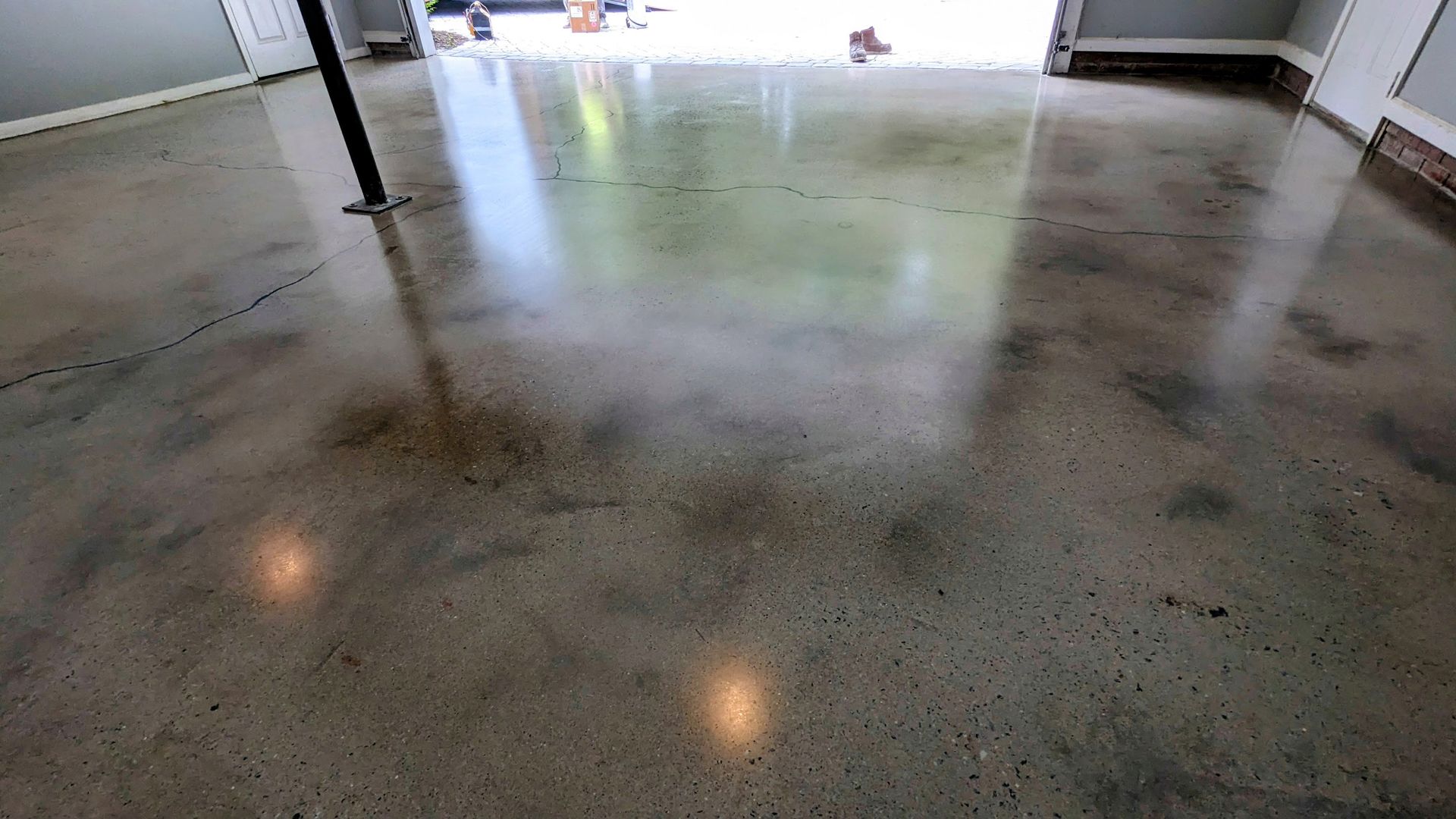 A close up of a shiny concrete floor in a garage.