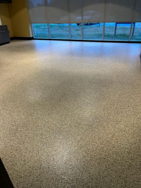 A large room with a shiny floor and a large window.