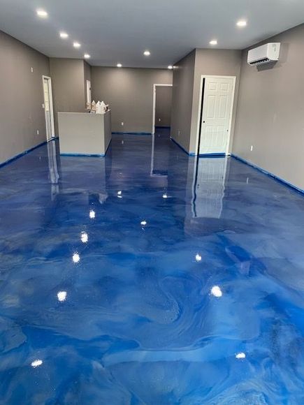 A large room with a blue metallic floor.