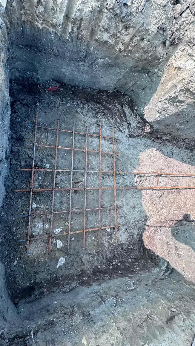 A person is standing in a hole in the ground.