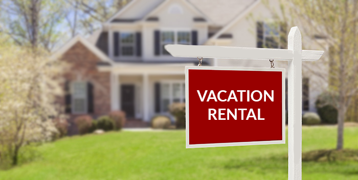 Vacation Rental Sign house is blurred